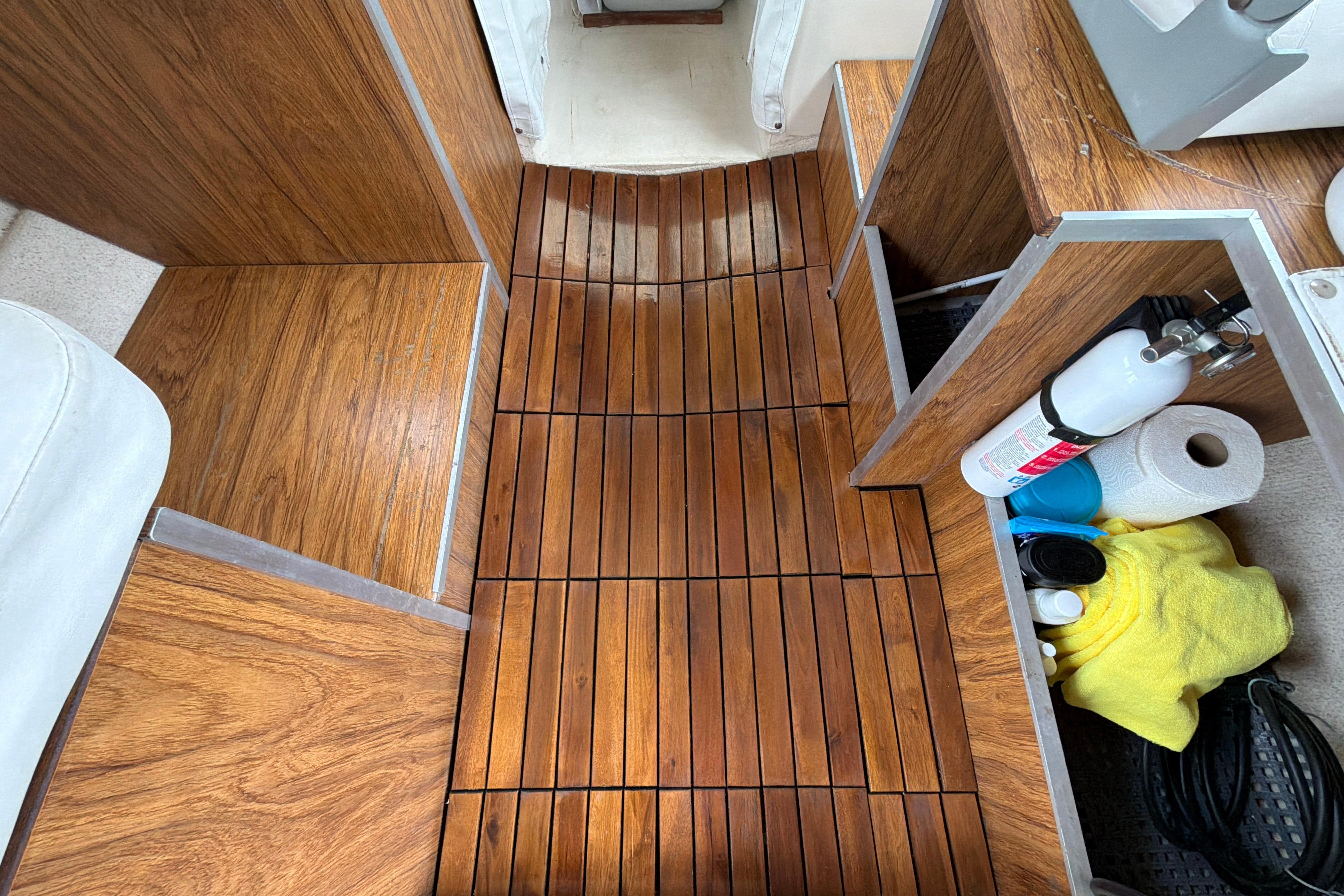 1989 C-Dory 22' Angler interior with wooden flooring and storage compartments.