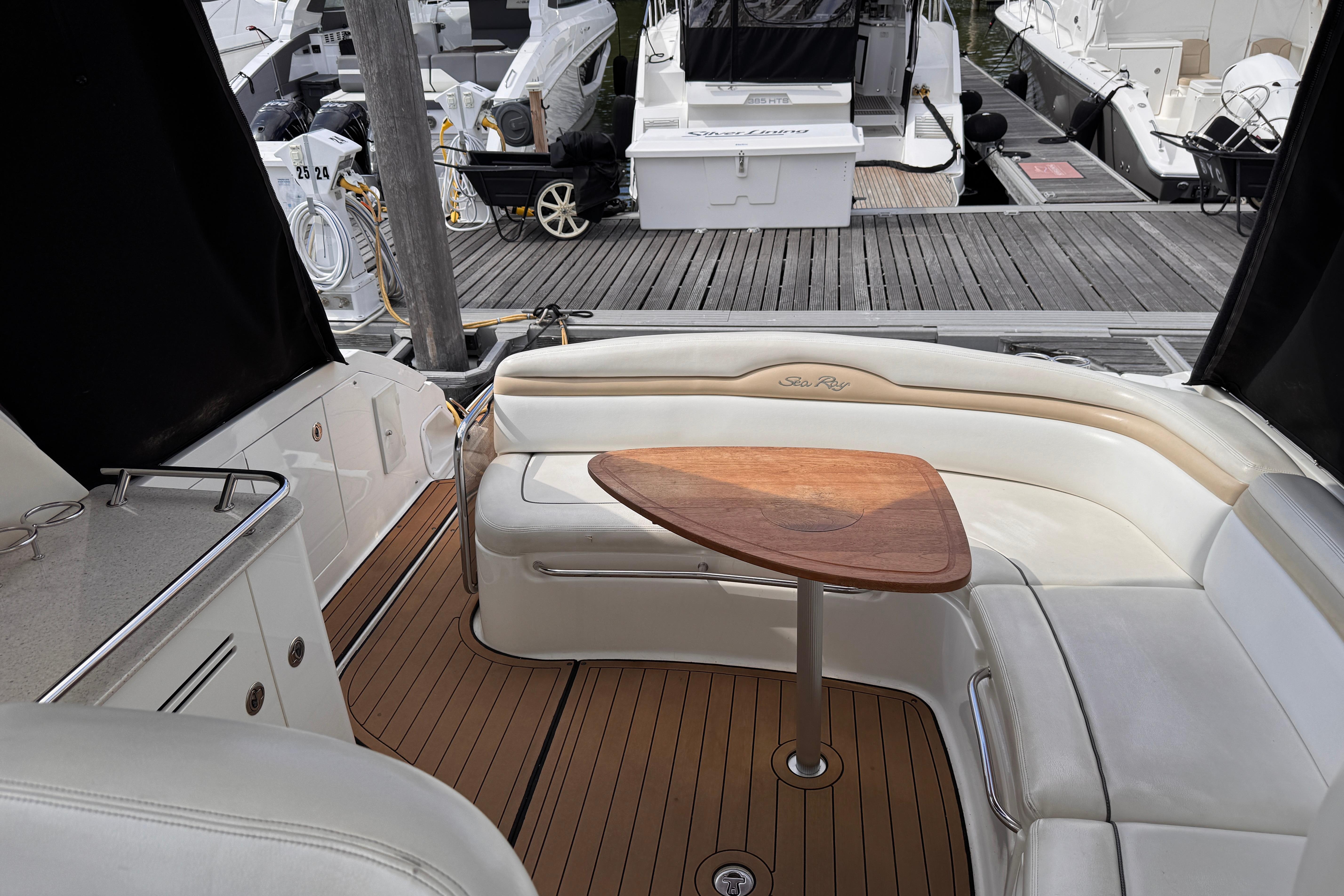 Luxurious 2008 Sea Ray Sundancer 350 yacht interior with elegant seating and wooden table.