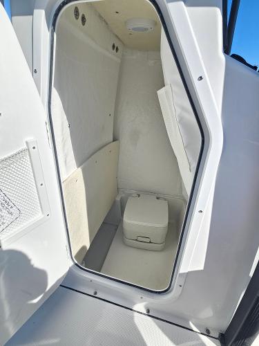 2026 Sea Hunt BX 22 BR boat interior with compact marine toilet.