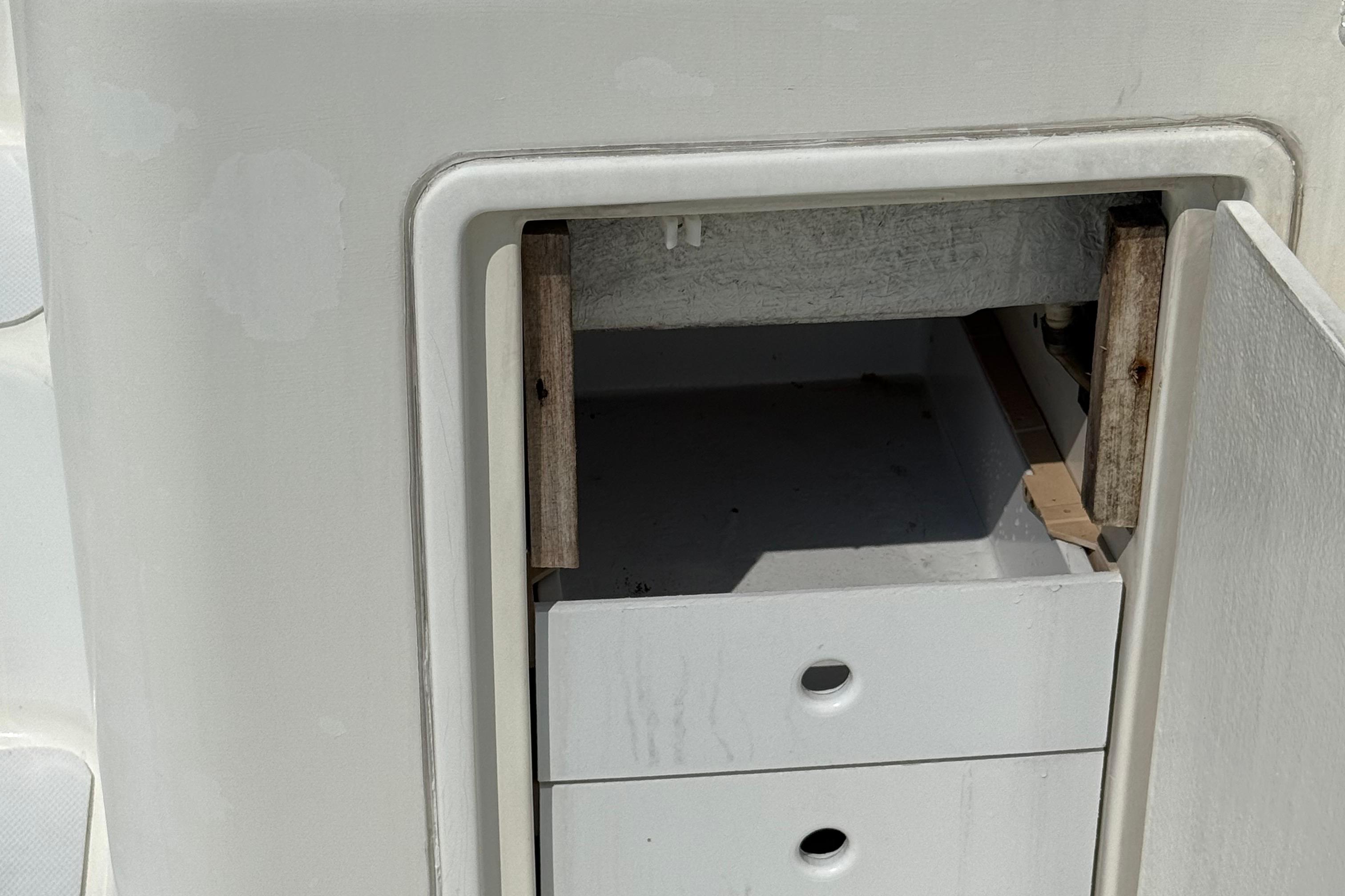 Open storage compartment on a 1999 Ocean Yachts 40 Express boat.