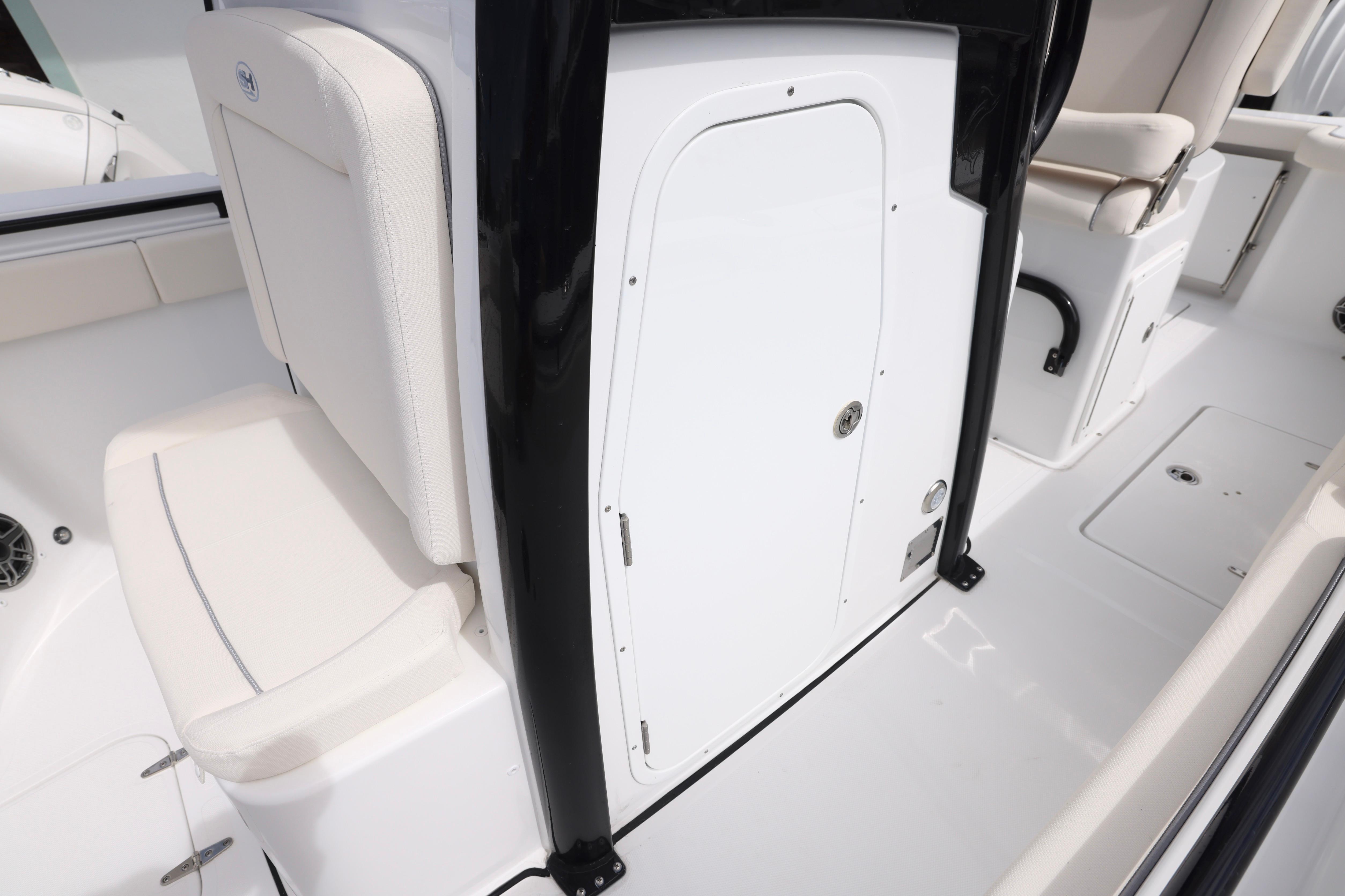 2026 Sea Hunt Gamefish 25 interior, featuring white seating and storage compartment.