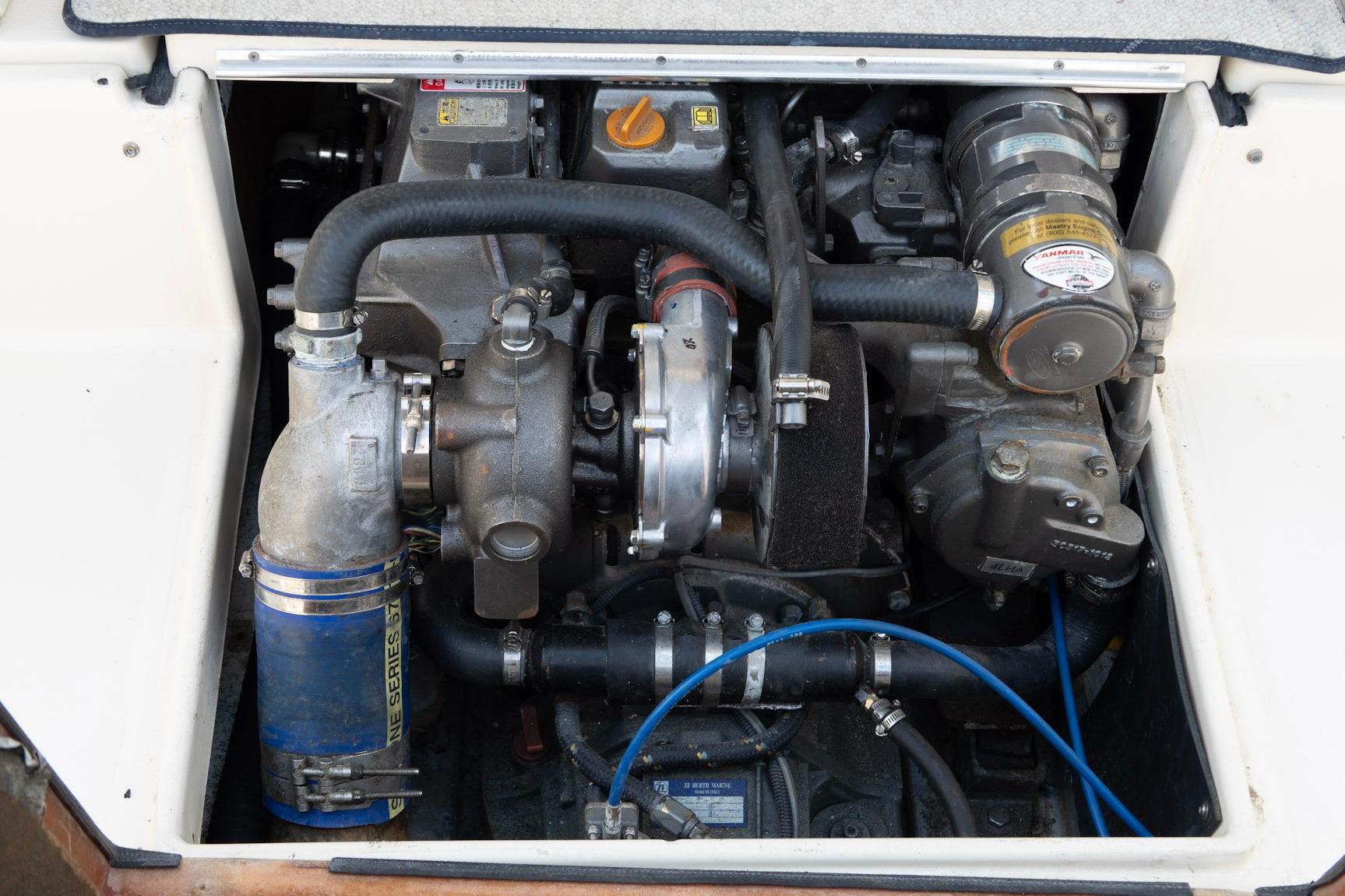 Engine compartment of a 2006 Atlas Boat Works Acadia 25, showcasing mechanical components.
