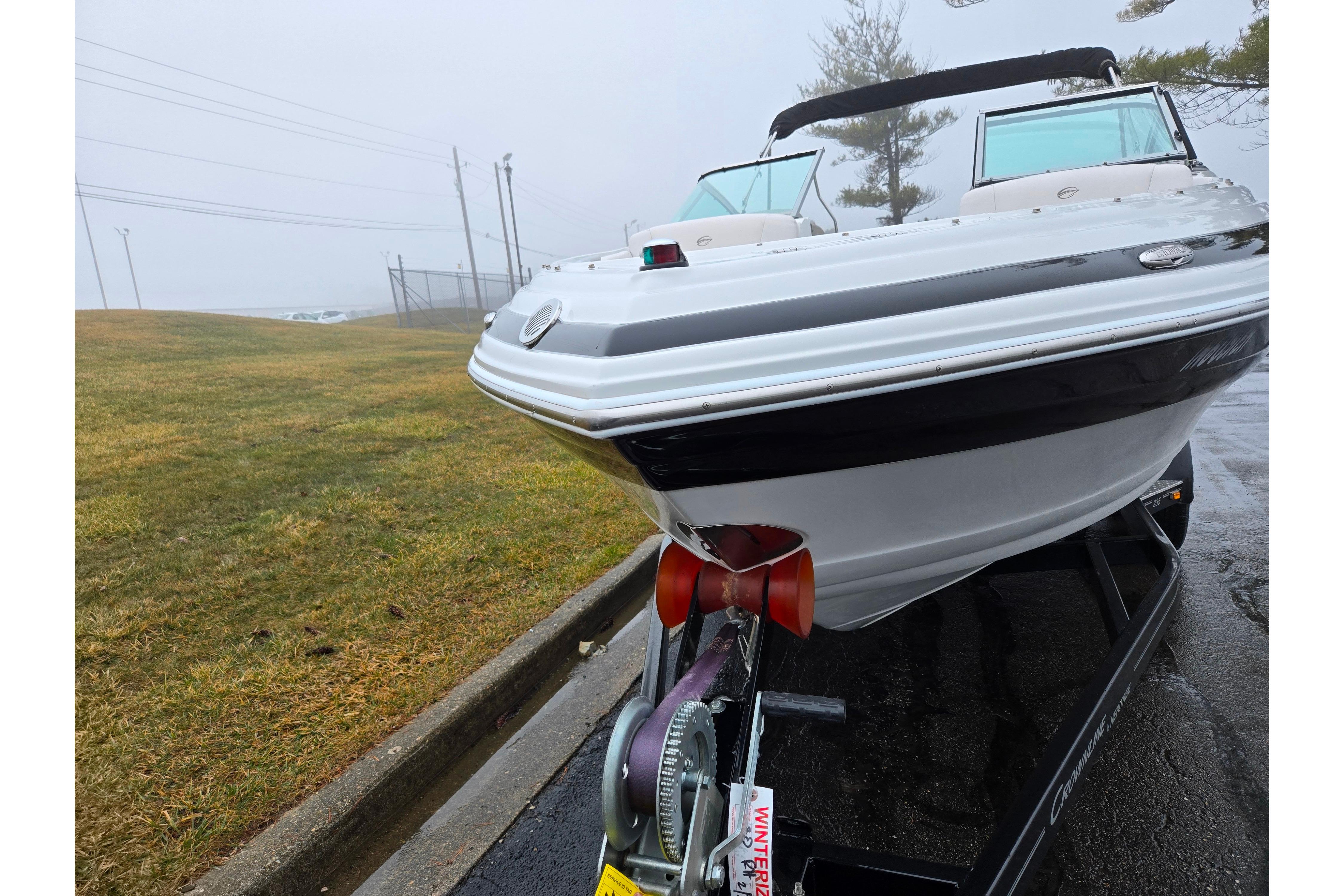 2012 Crownline 235 SS boat on trailer in foggy outdoor setting.