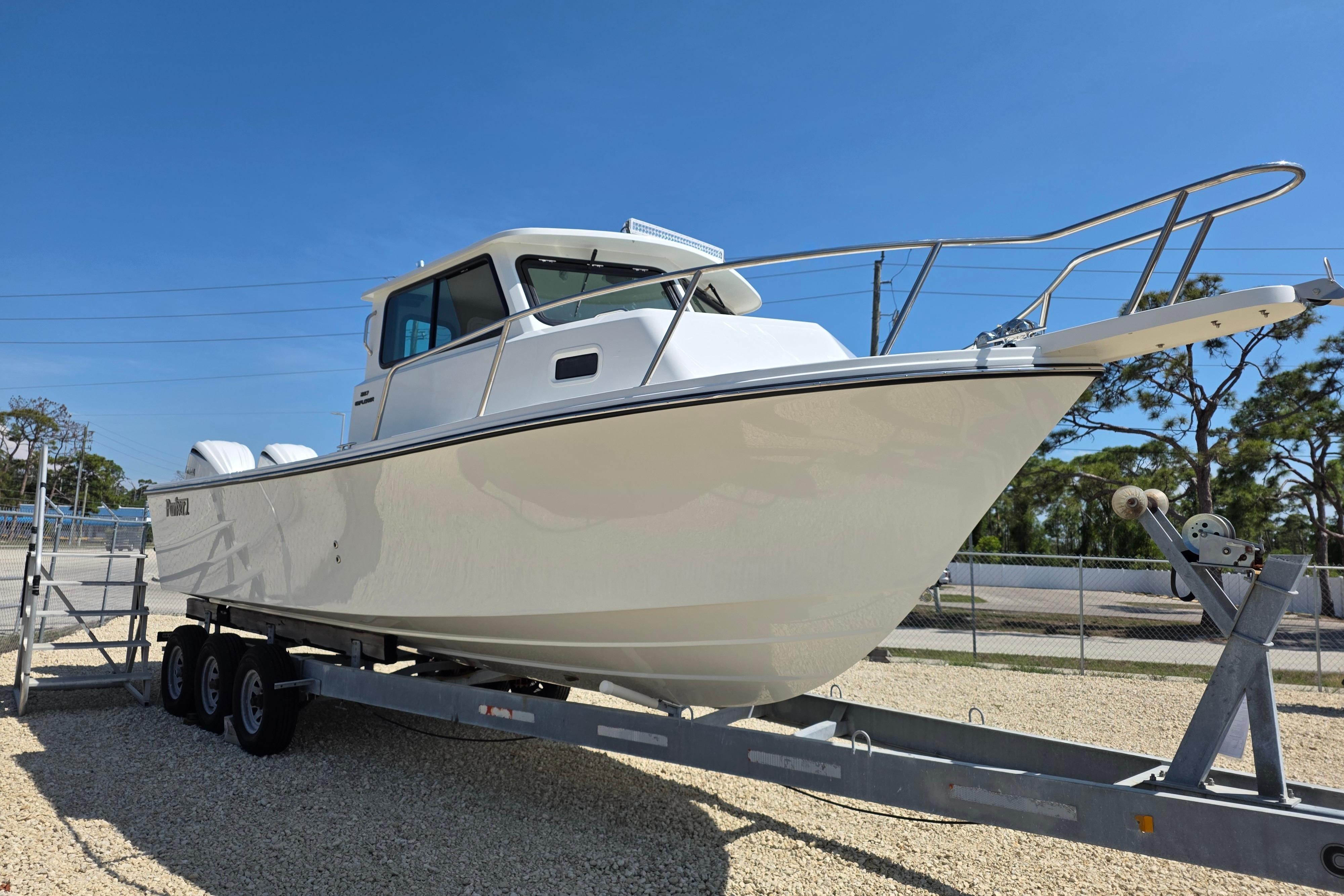 2026 Parker 287 Explorer boat on trailer, displayed outdoors under clear blue sky.