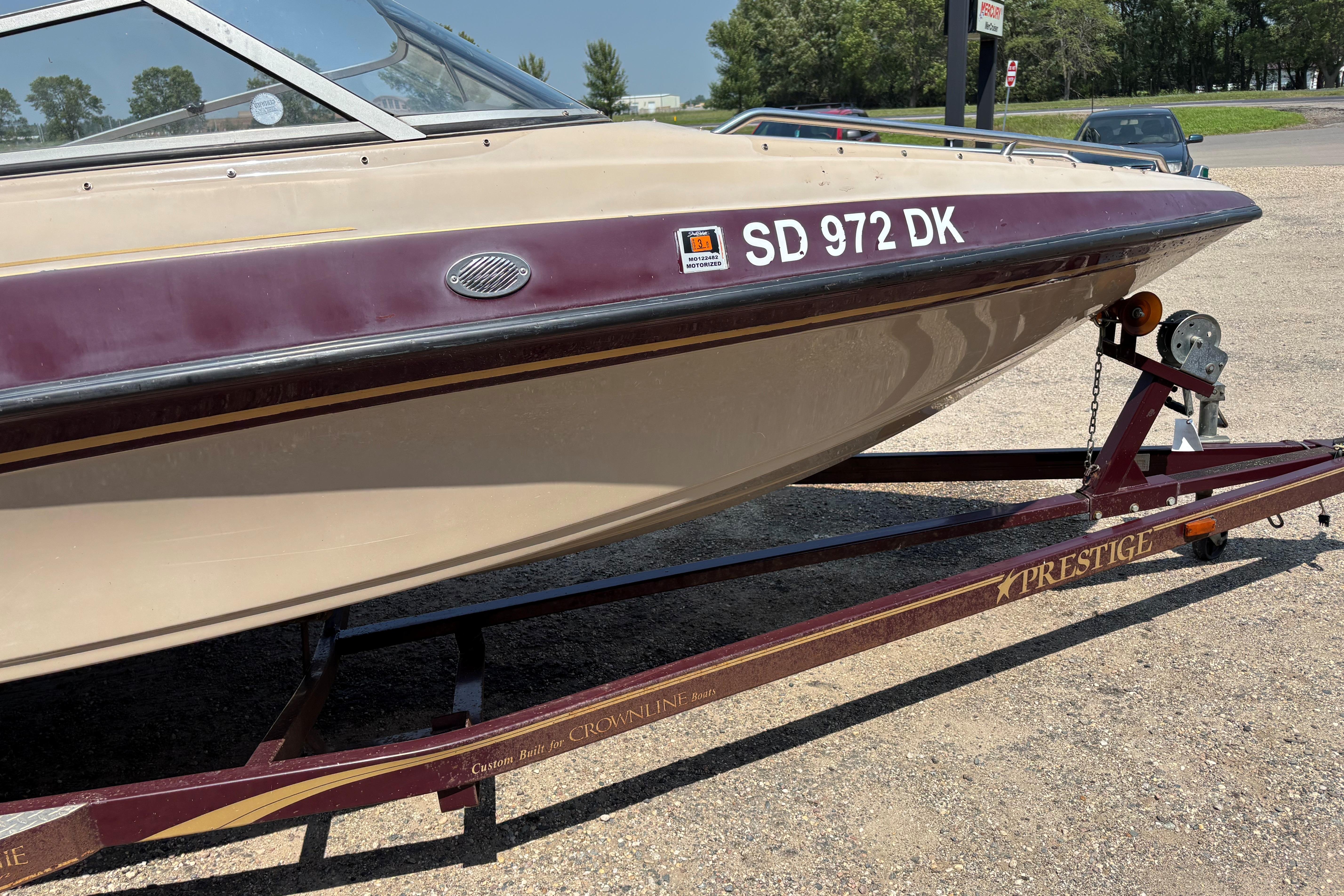 2001 Crownline 18' boat on Prestige trailer, parked on gravel.