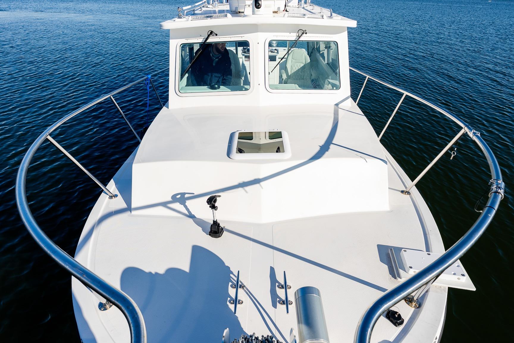 2024 Steiger Craft 31 Fisherman boat on calm water, showcasing bow and cabin.