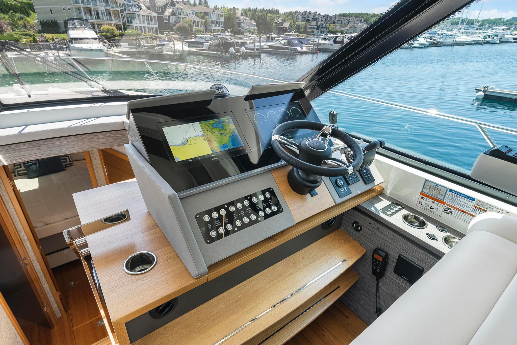 2022 Tiara Yachts C49 Coupe helm with modern controls and waterfront view.