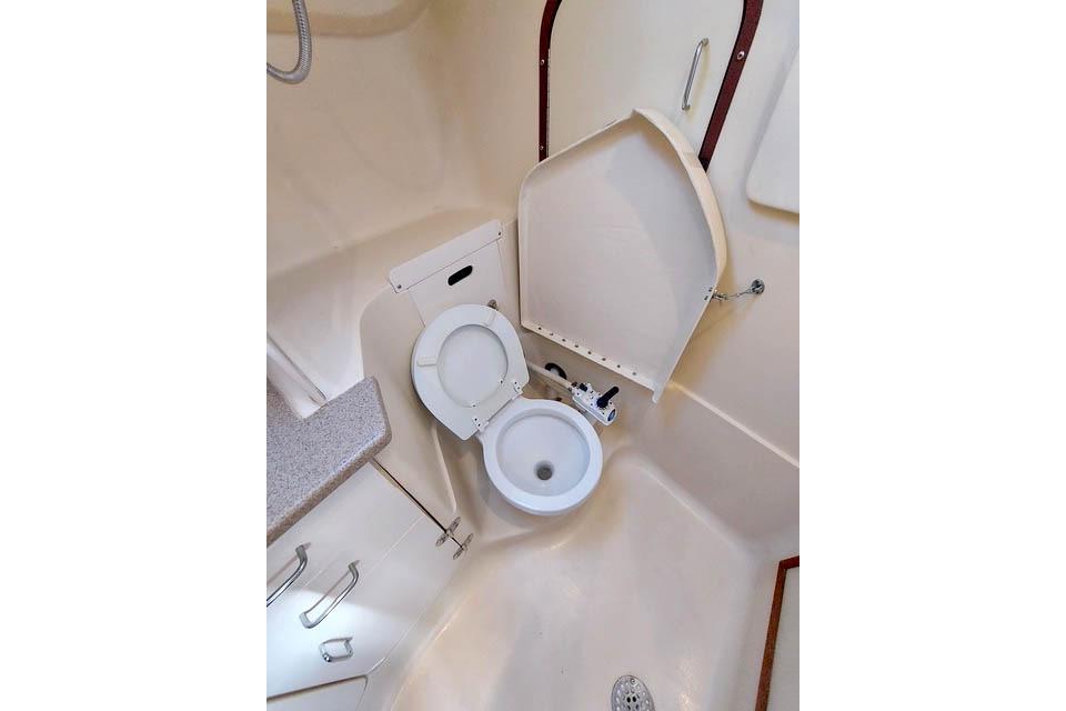 1998 Hunter 340 sailboat bathroom with compact toilet and shower area.
