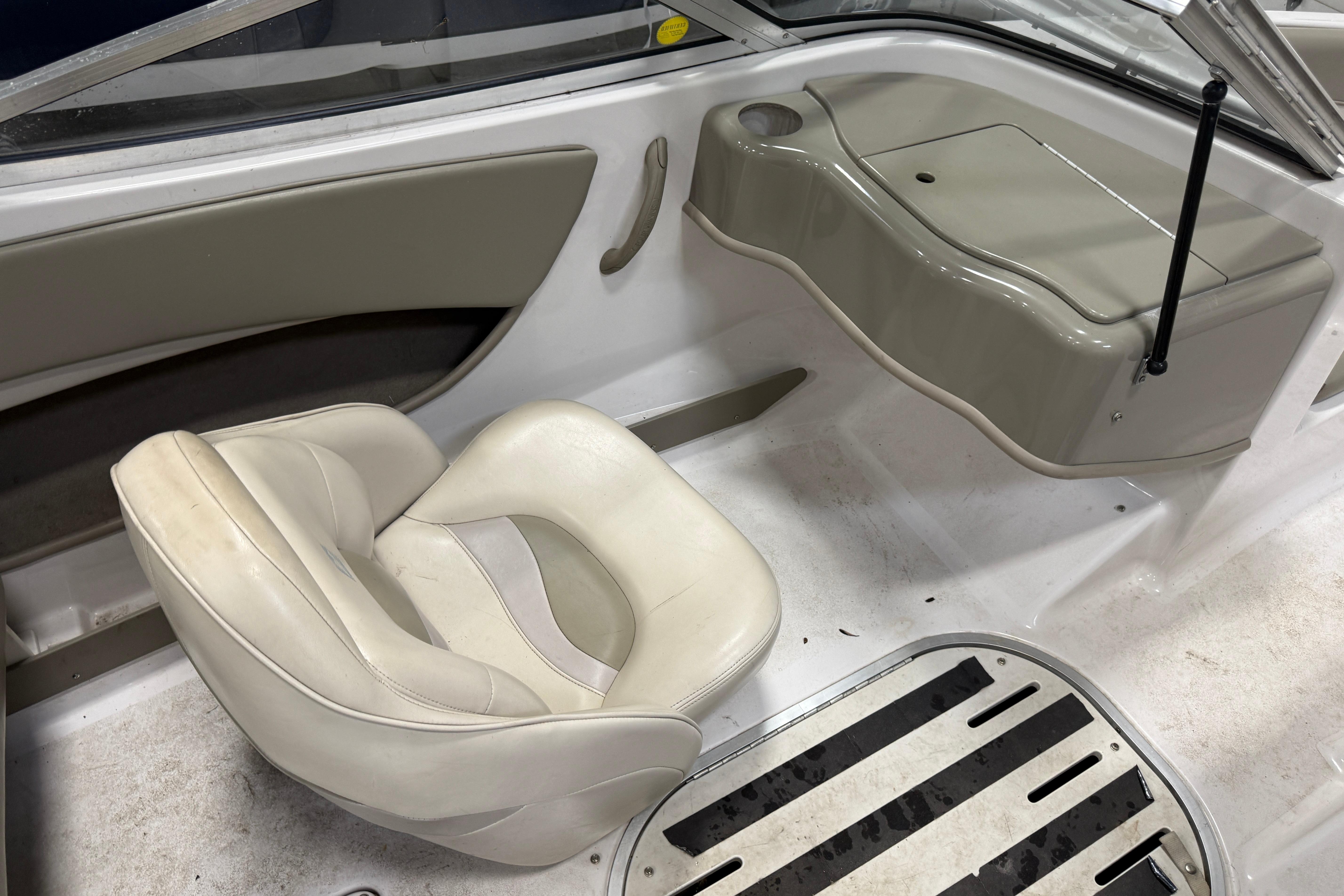 Interior of 1999 Four Winns 170 Horizon LE boat with white seating and dashboard.