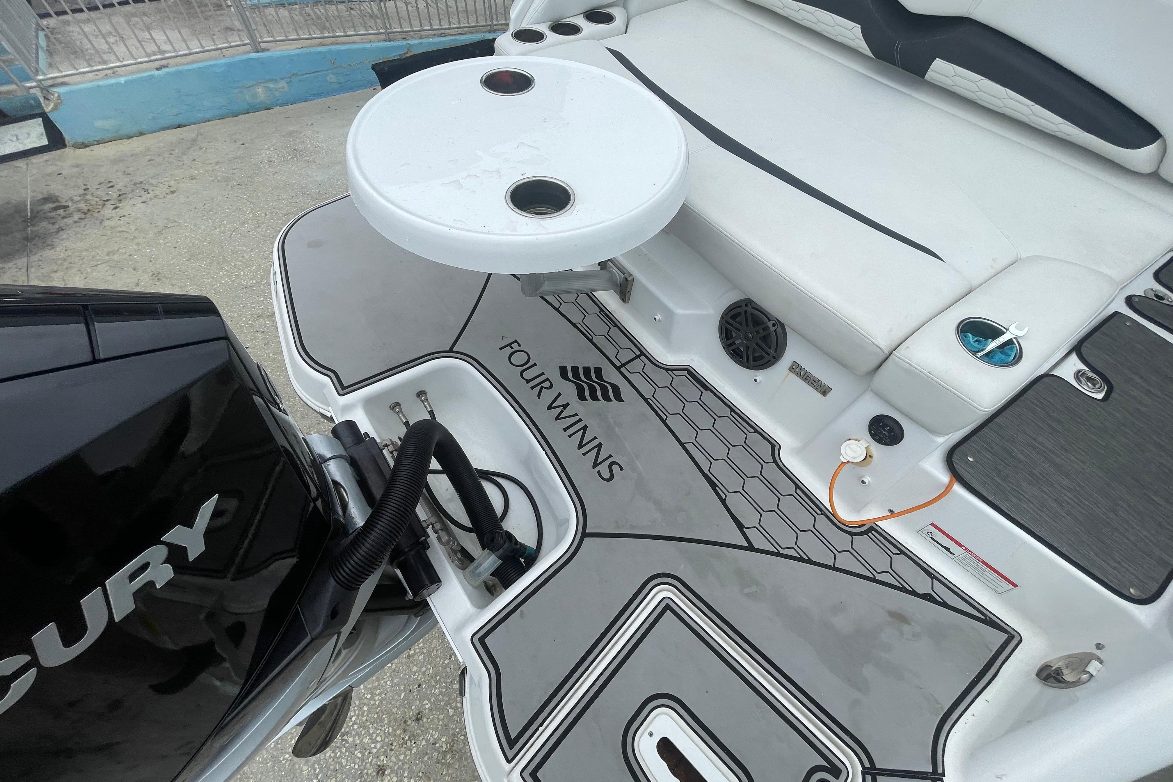 2022 Four Winns HD8 OB boat deck with seating and Mercury engine.