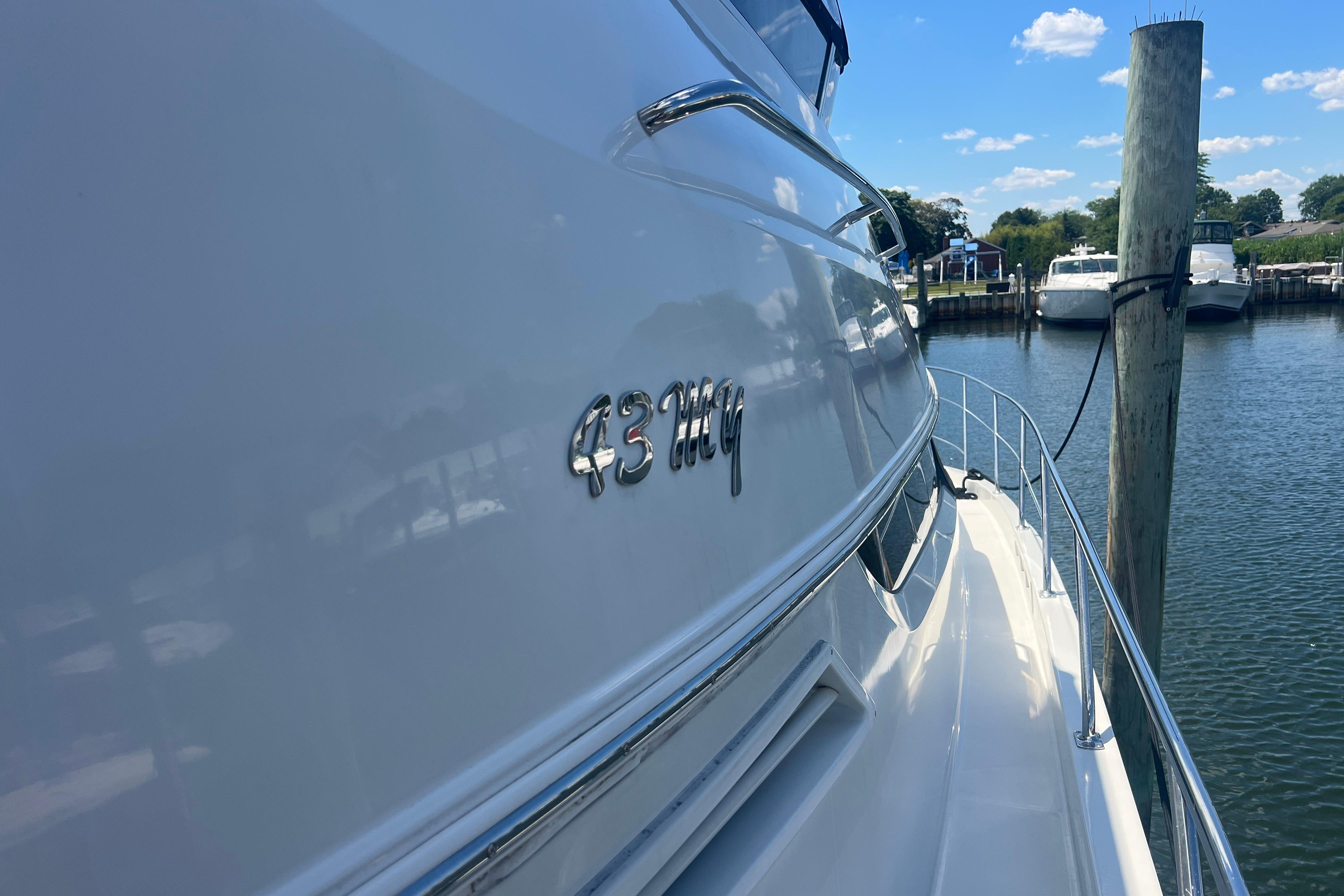 2006 Carver 43 Motor Yacht docked, showcasing sleek design and chrome lettering.
