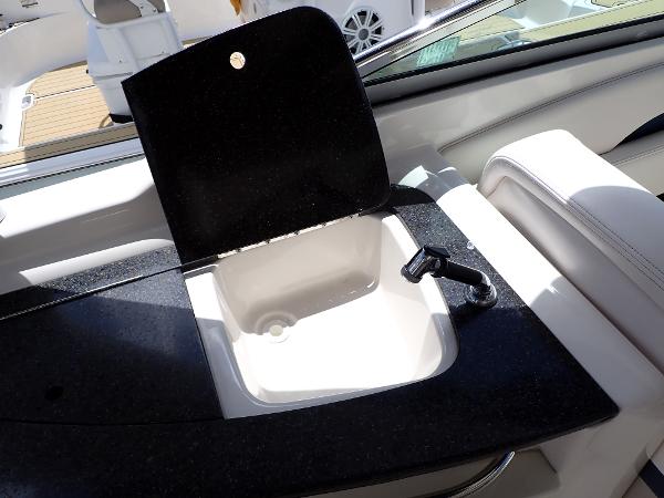 Chaparral 287 SSX 2011 boat sink with black countertop and faucet.