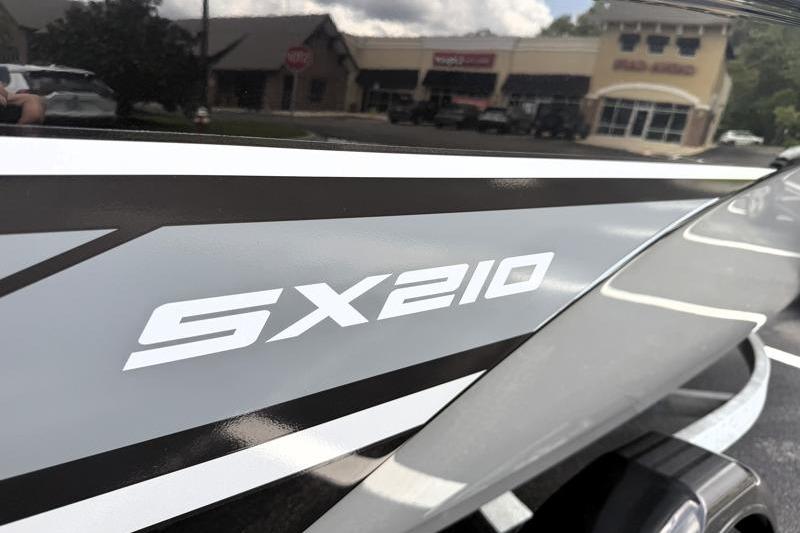 Close-up of 2017 Yamaha Boats SX210 logo on sleek exterior design.