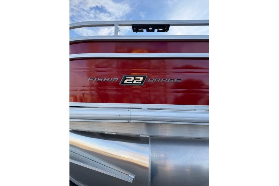 2026 Sun Tracker Fishin' Barge 22 XP3, red exterior with logo detail.