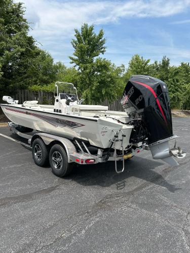 2024 Ranger RB210 boat on trailer with powerful outboard motor, parked outdoors.