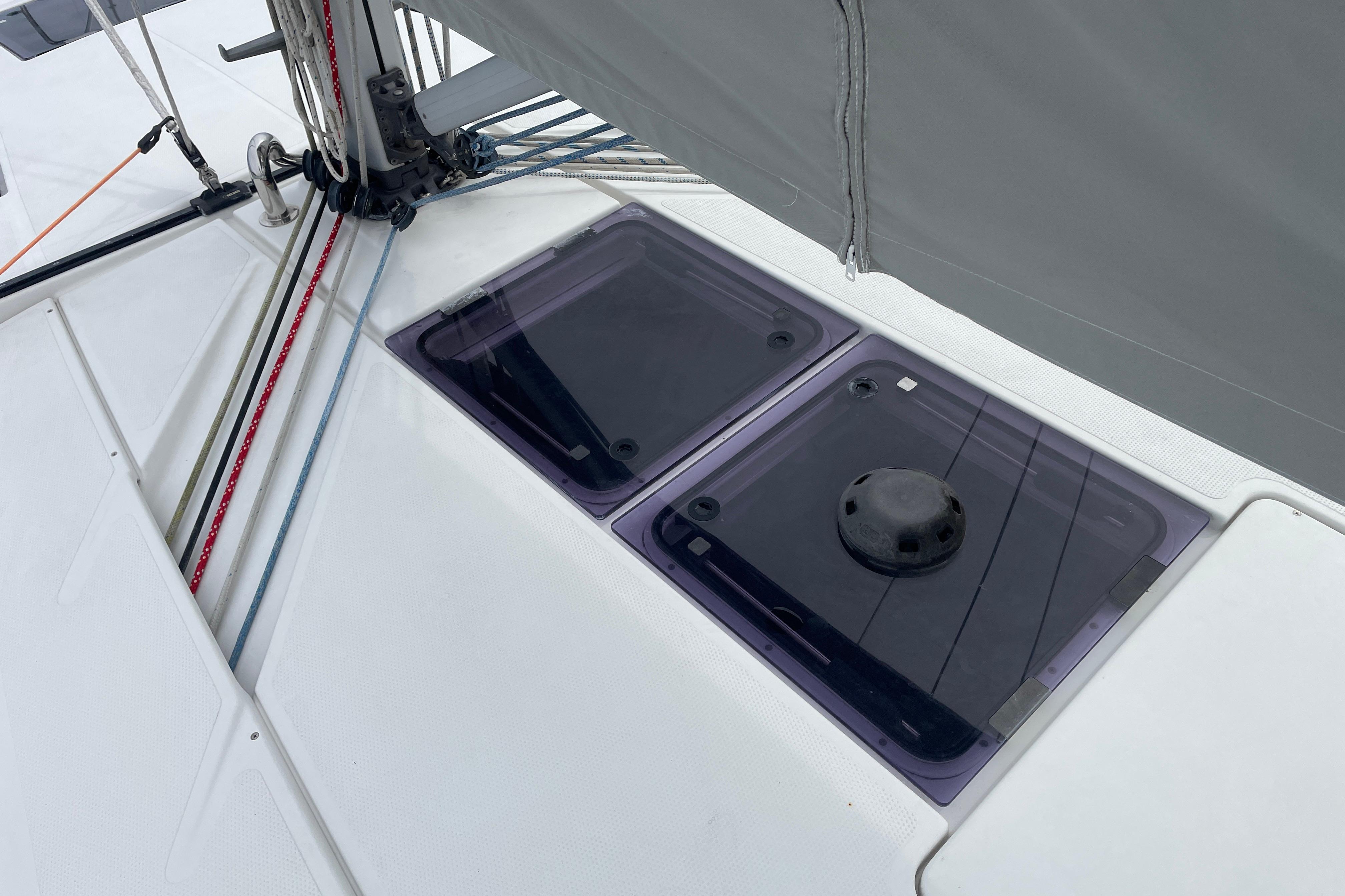 Deck of 2014 Hanse 415 sailboat with ropes and hatches visible.