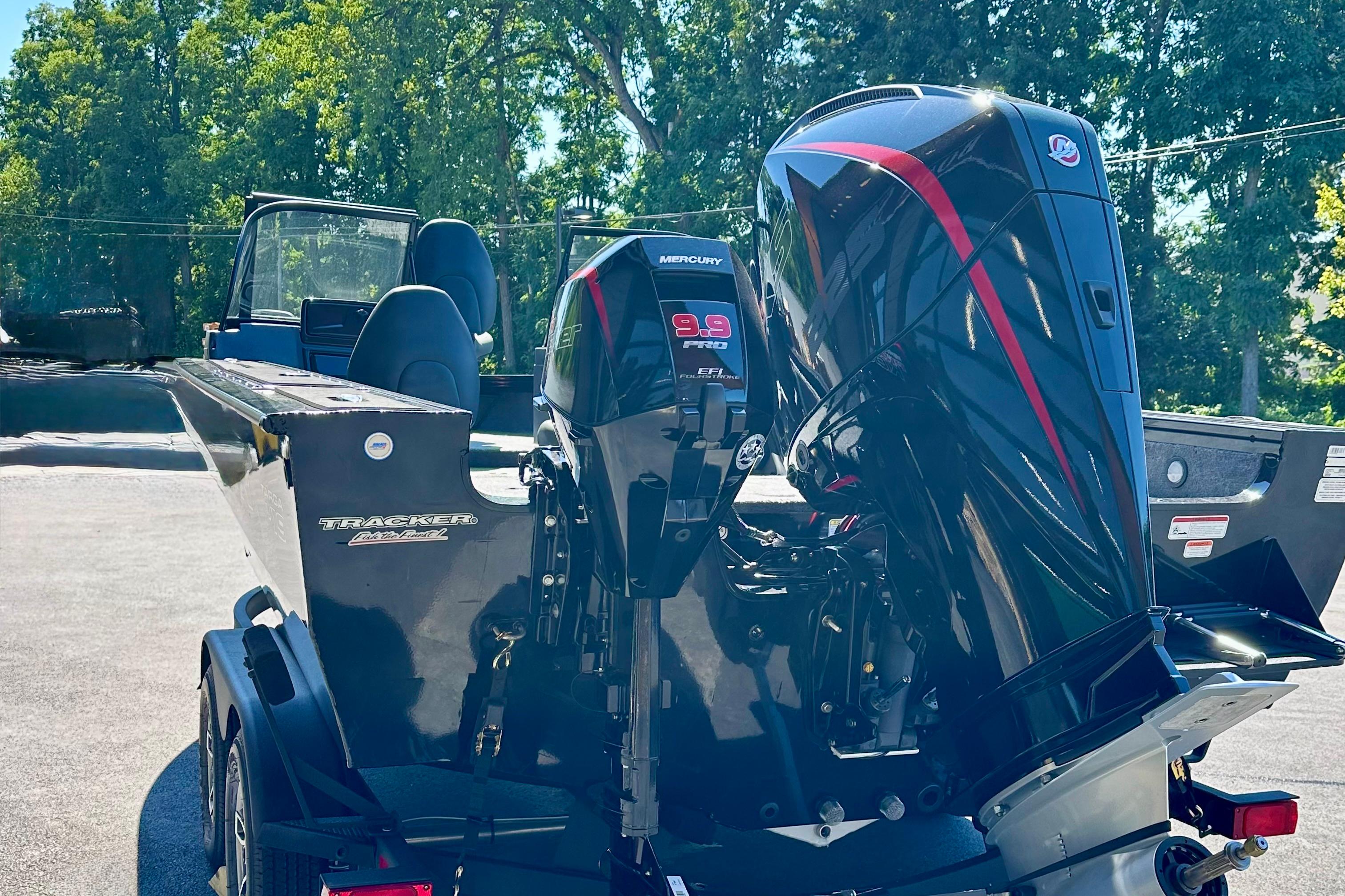 2026 Tracker Targa V-19 WT boat with dual Mercury engines, parked outdoors.