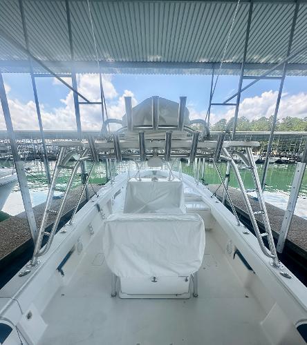 2008 SeaVee 390B boat docked under a canopy with clear skies.