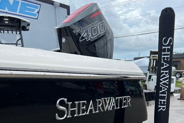 2024 ShearWater 260 Carolina Flare boat with Racing 400 engine, docked outdoors.