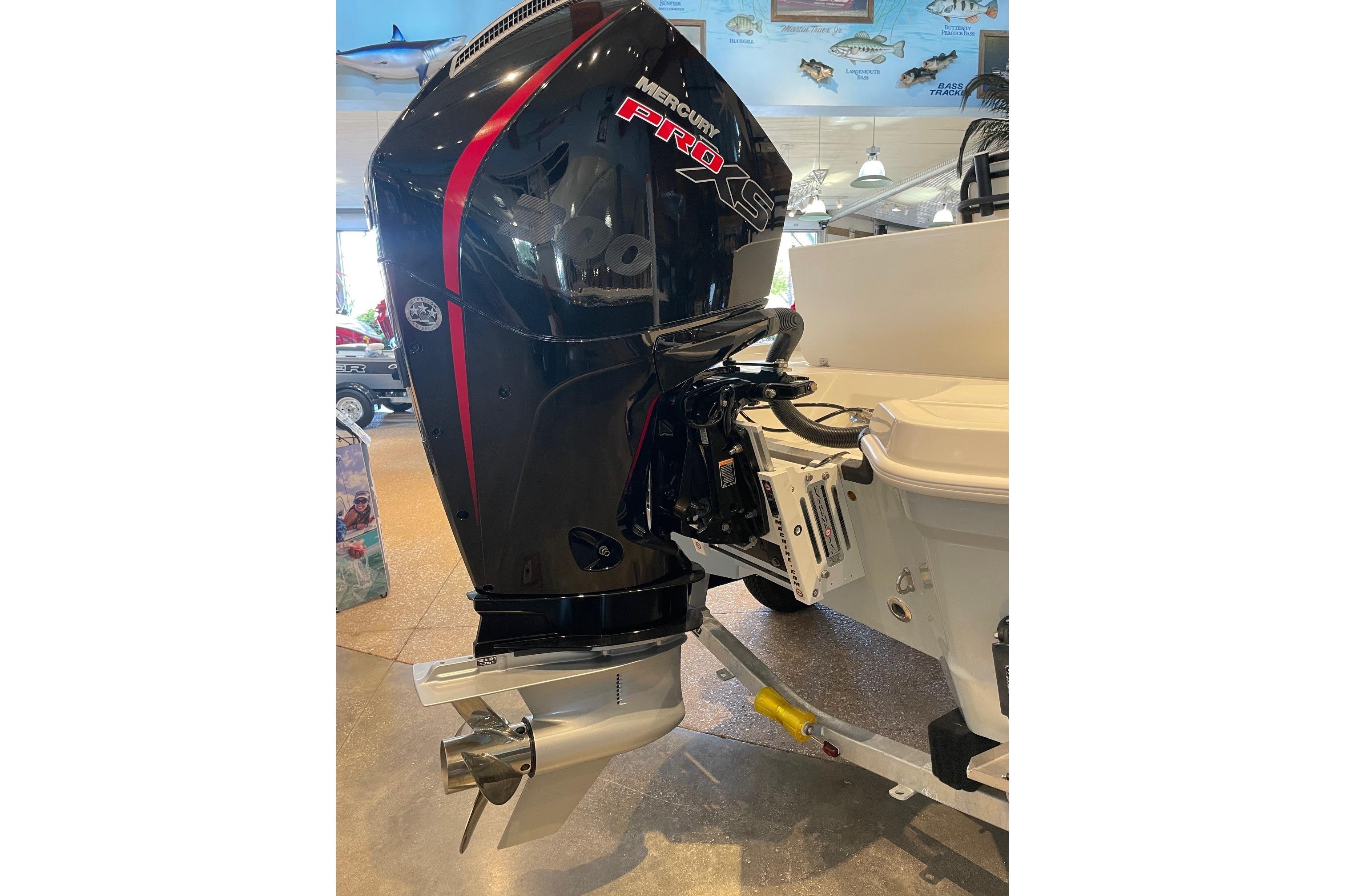 2026 Mako 24 APEX boat with Mercury Pro XS outboard motor in showroom.