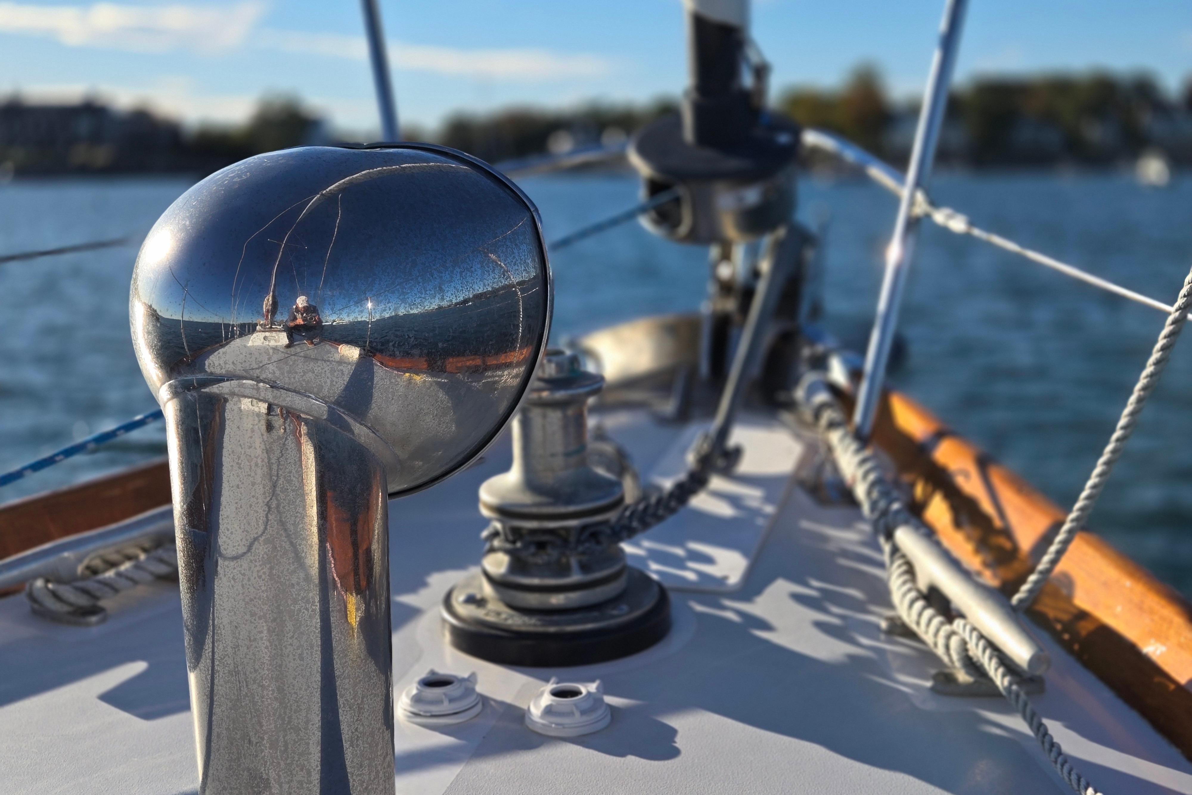 Close-up of 1970 Hinckley Bermuda 40 sailboat deck with polished metal fittings.