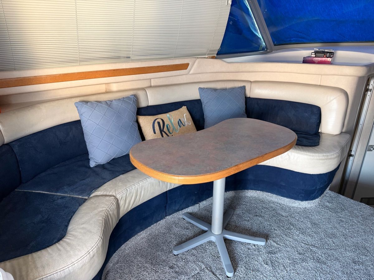 Interior of the 1996 Sea Ray 370 Sedan Bridge with cozy seating area and table.