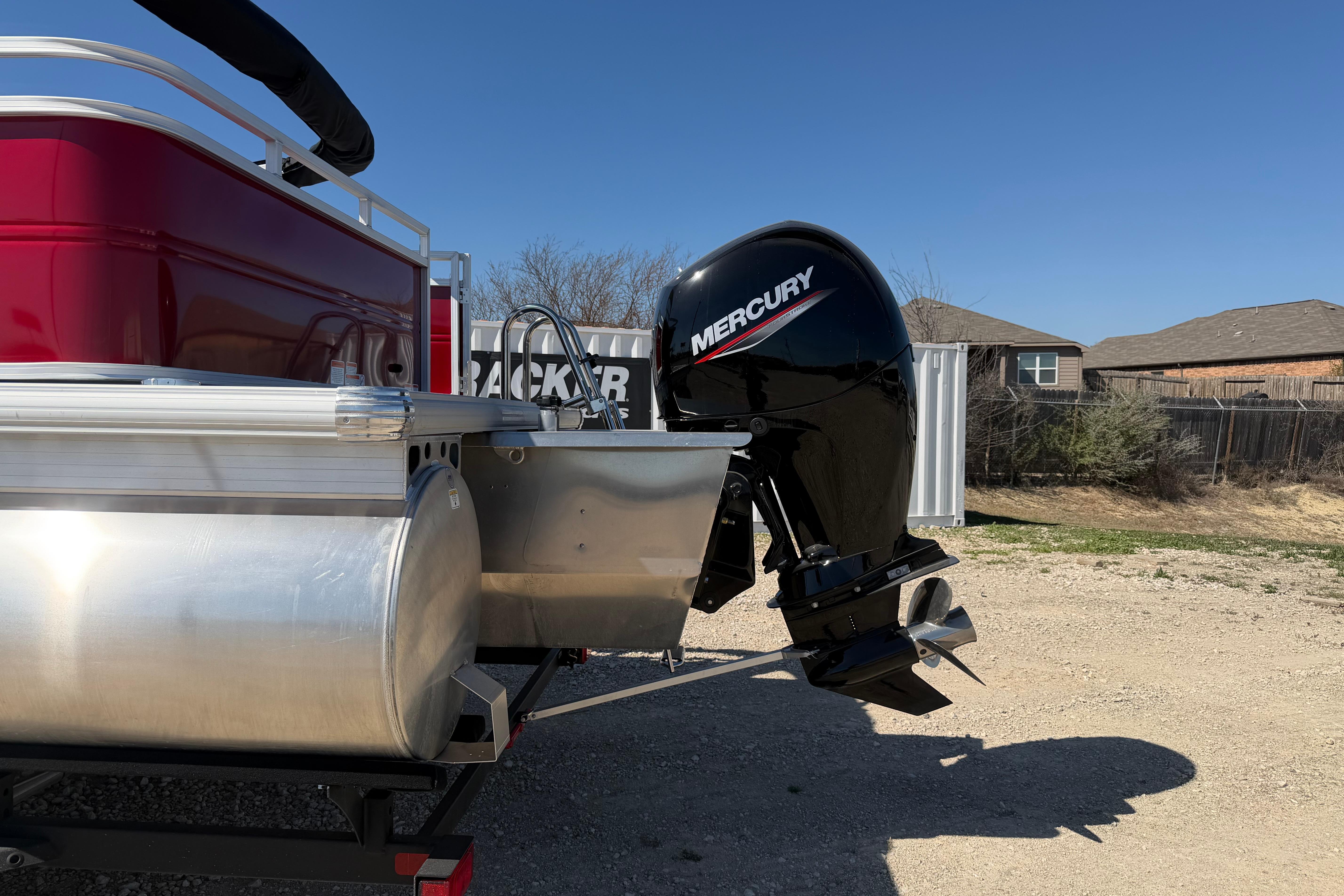 2026 Sun Tracker Party Barge 22 RF XP3 with Mercury outboard motor, parked outdoors.