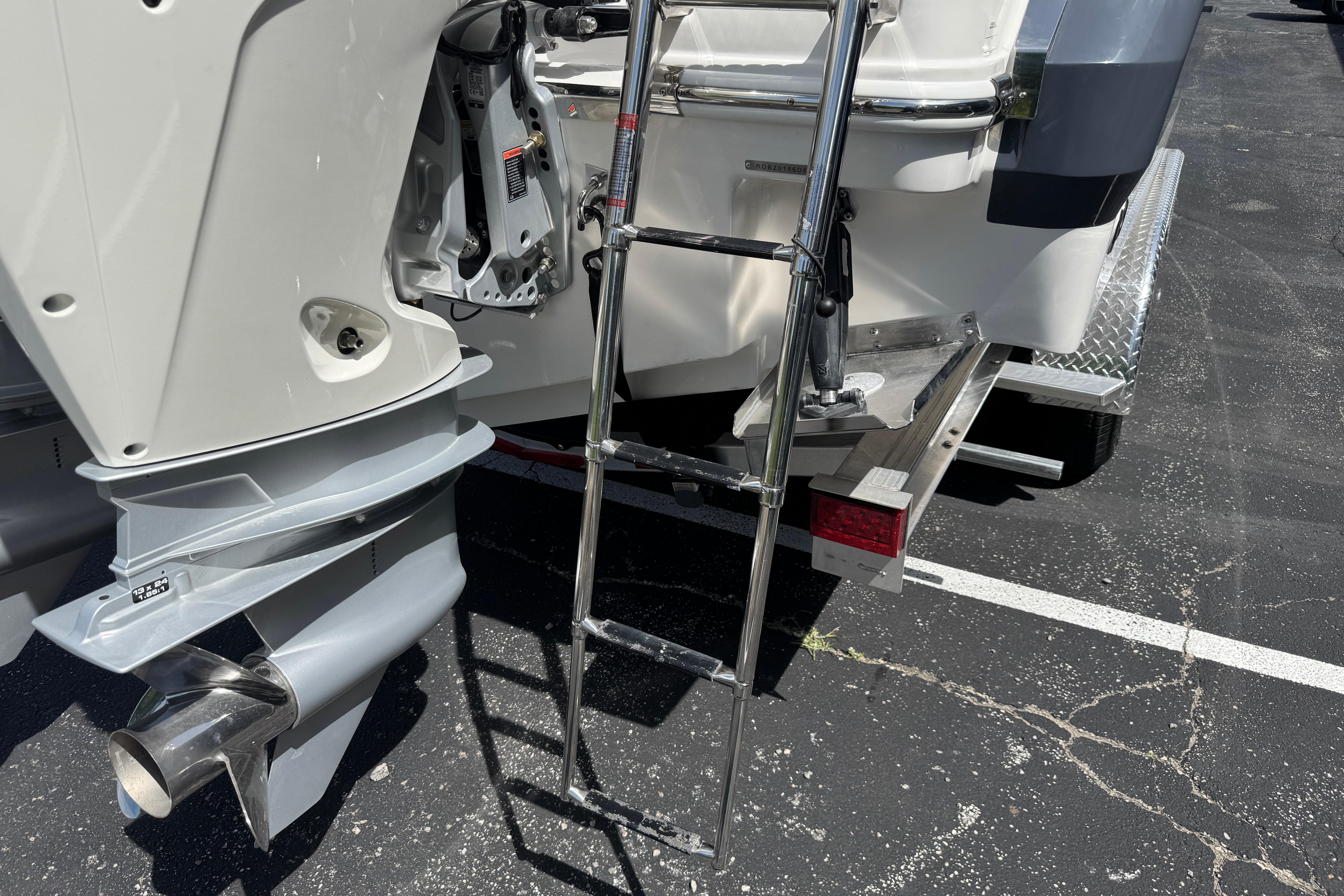 2026 Robalo R250 Center Console boat with ladder and outboard motor detail.