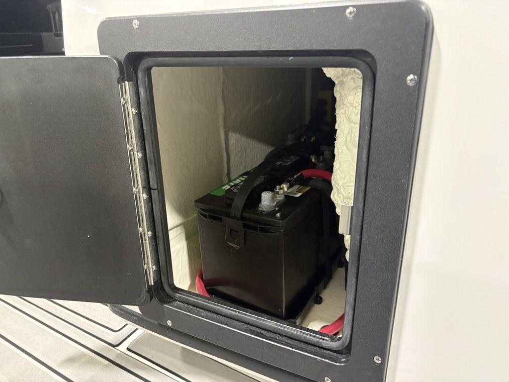 Battery compartment of 2026 Tidewater 2700 CB boat, showing installed battery.