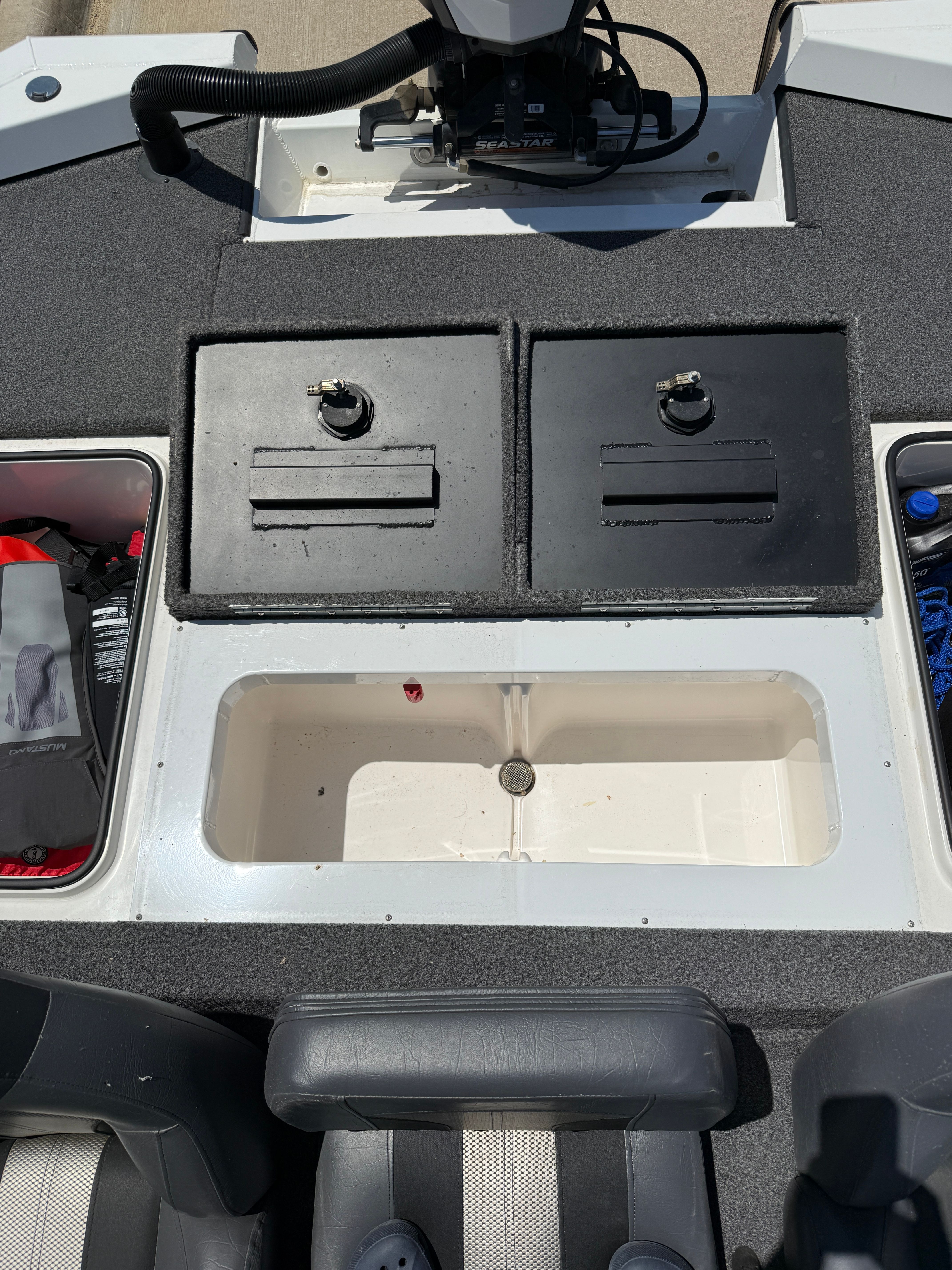 The image shows the cockpit of a 2019 Vexus AVX1980 boat with storage compartments and seating.