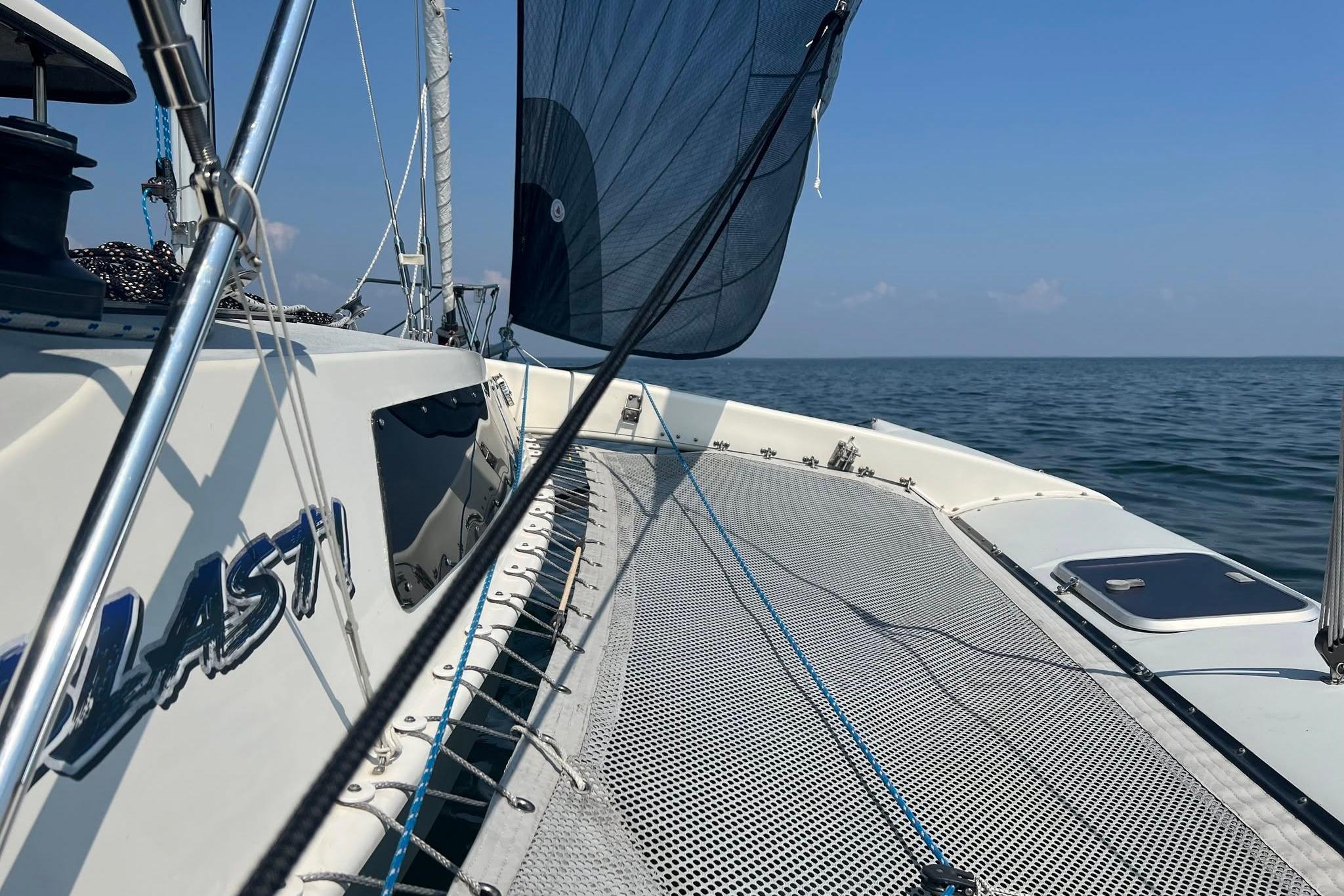 Sailing on a 1993 Corsair F-27 trimaran with blue skies and calm sea.