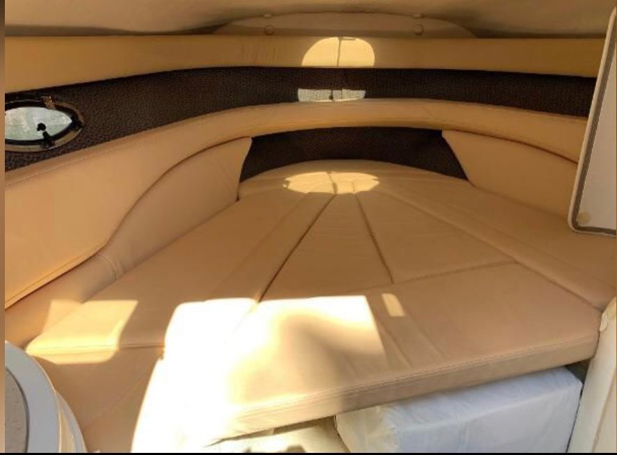 Interior of a 1999 Cobalt 293 boat with beige upholstery.
