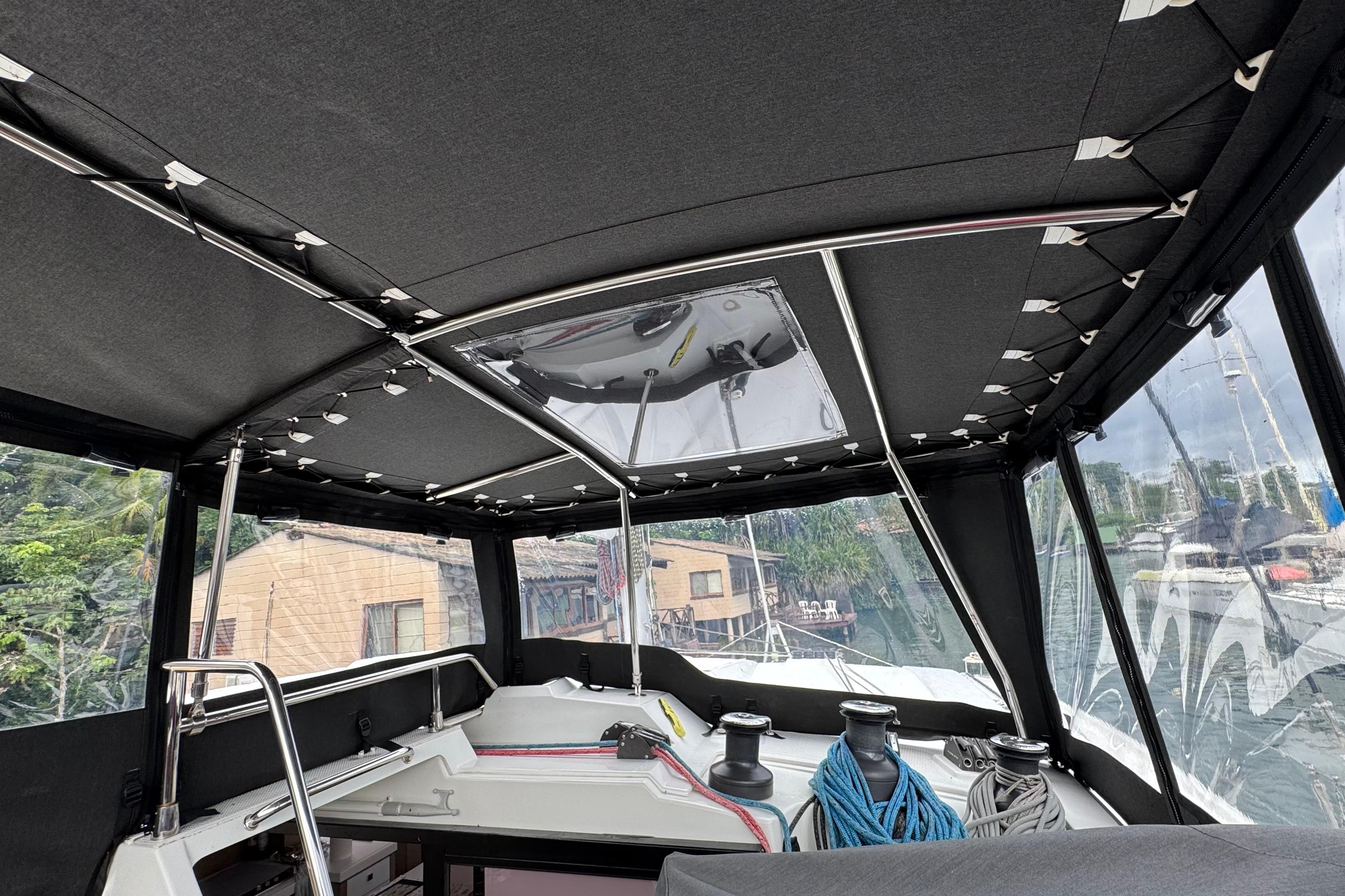 Interior view of 2020 Fountaine Pajot Saona 47 catamaran cockpit with canopy and ropes.