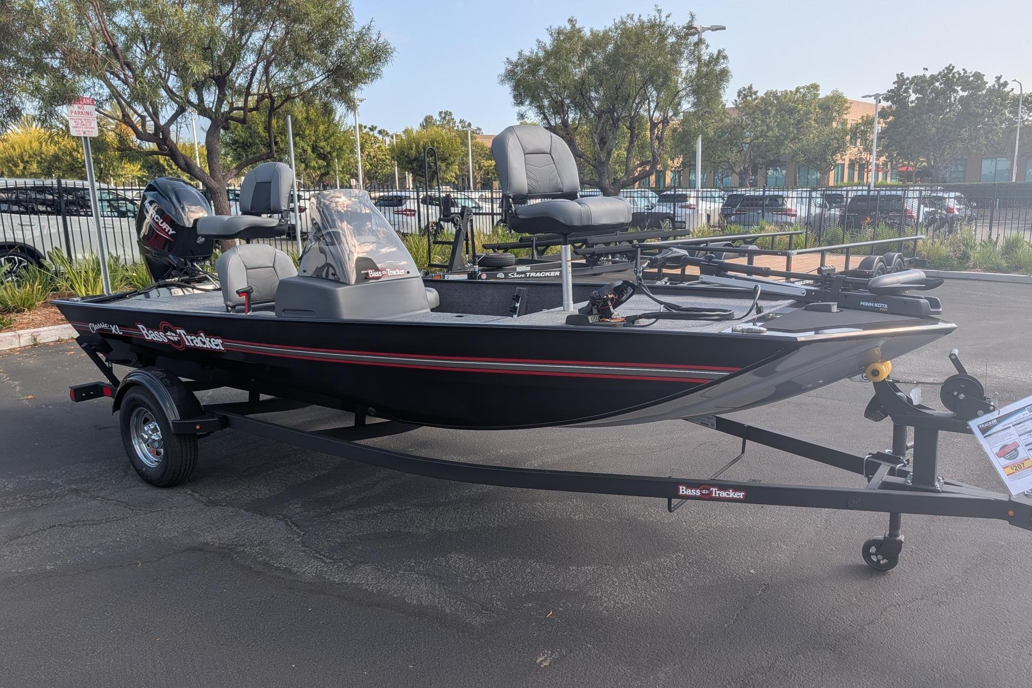 2026 Tracker Bass Tracker Classic XL boat on trailer in parking lot.