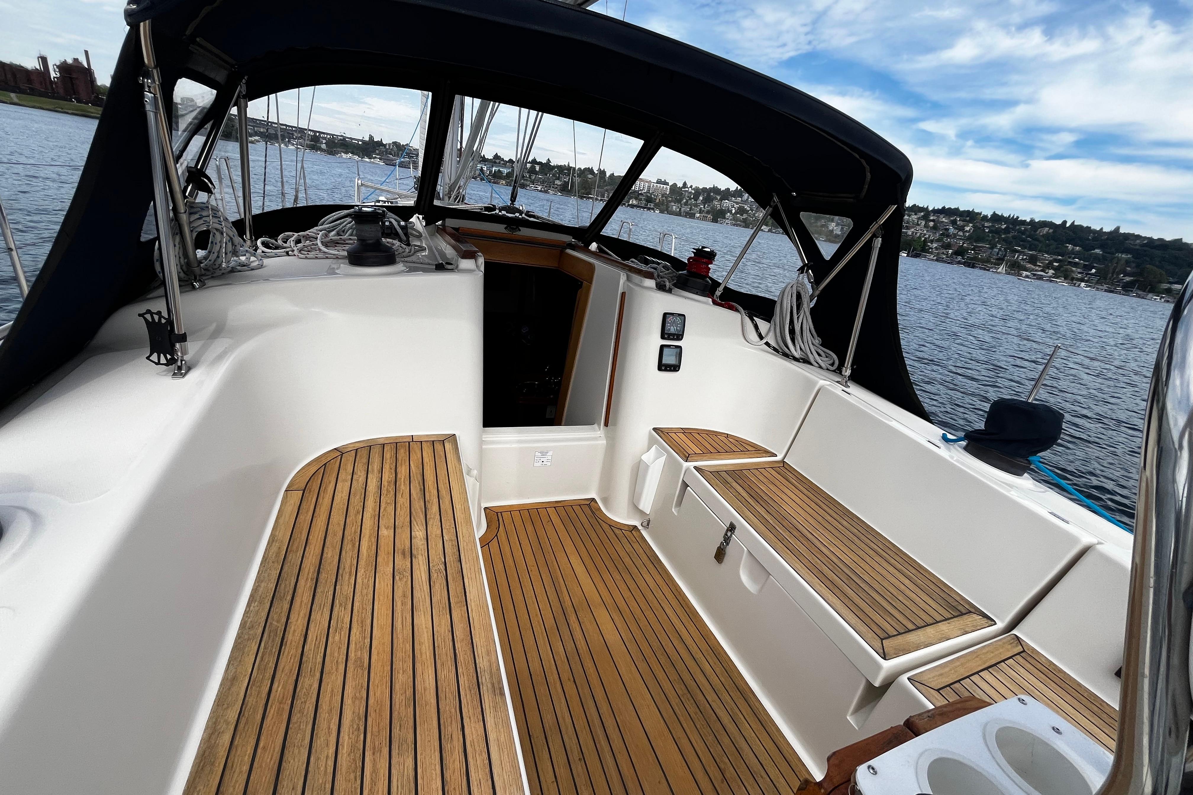 2004 Hanse 411 sailboat cockpit with teak flooring, docked on a scenic waterfront.
