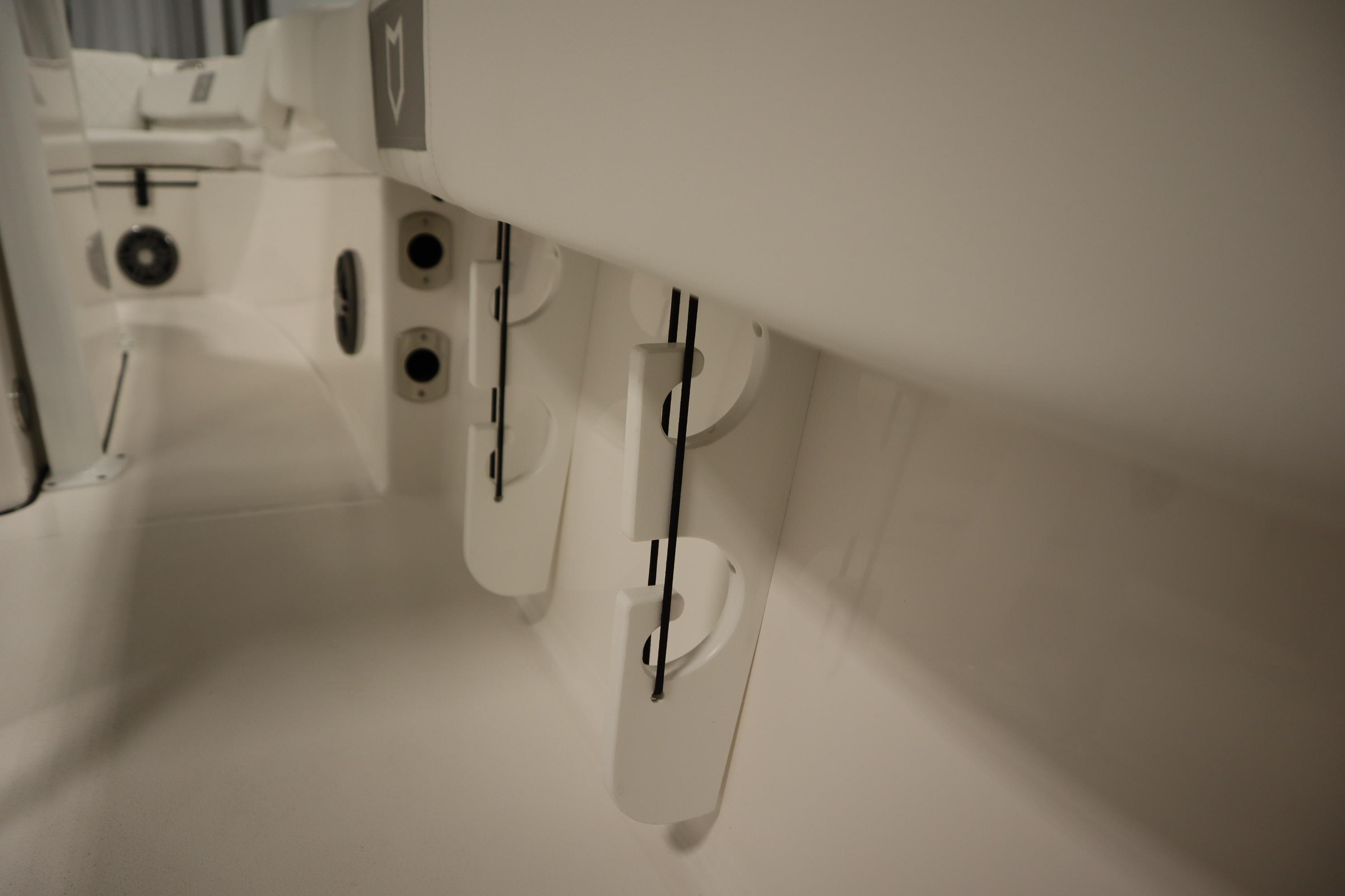 Interior view of 2026 Sea Fox 228 Commander boat, showcasing rod holders and seating area.