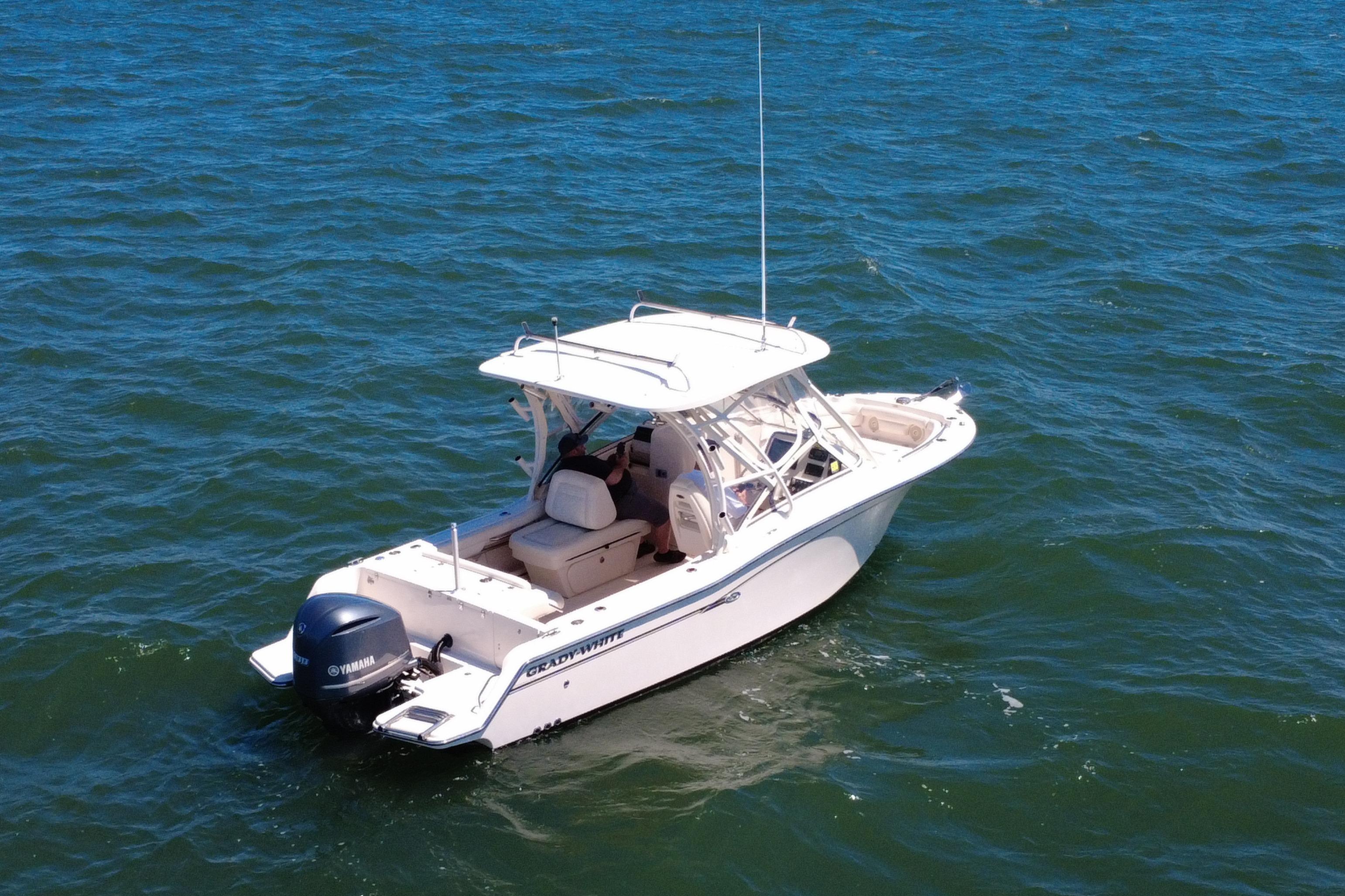 2017 Grady-White Freedom 235 boat on open water, featuring a Yamaha outboard motor.