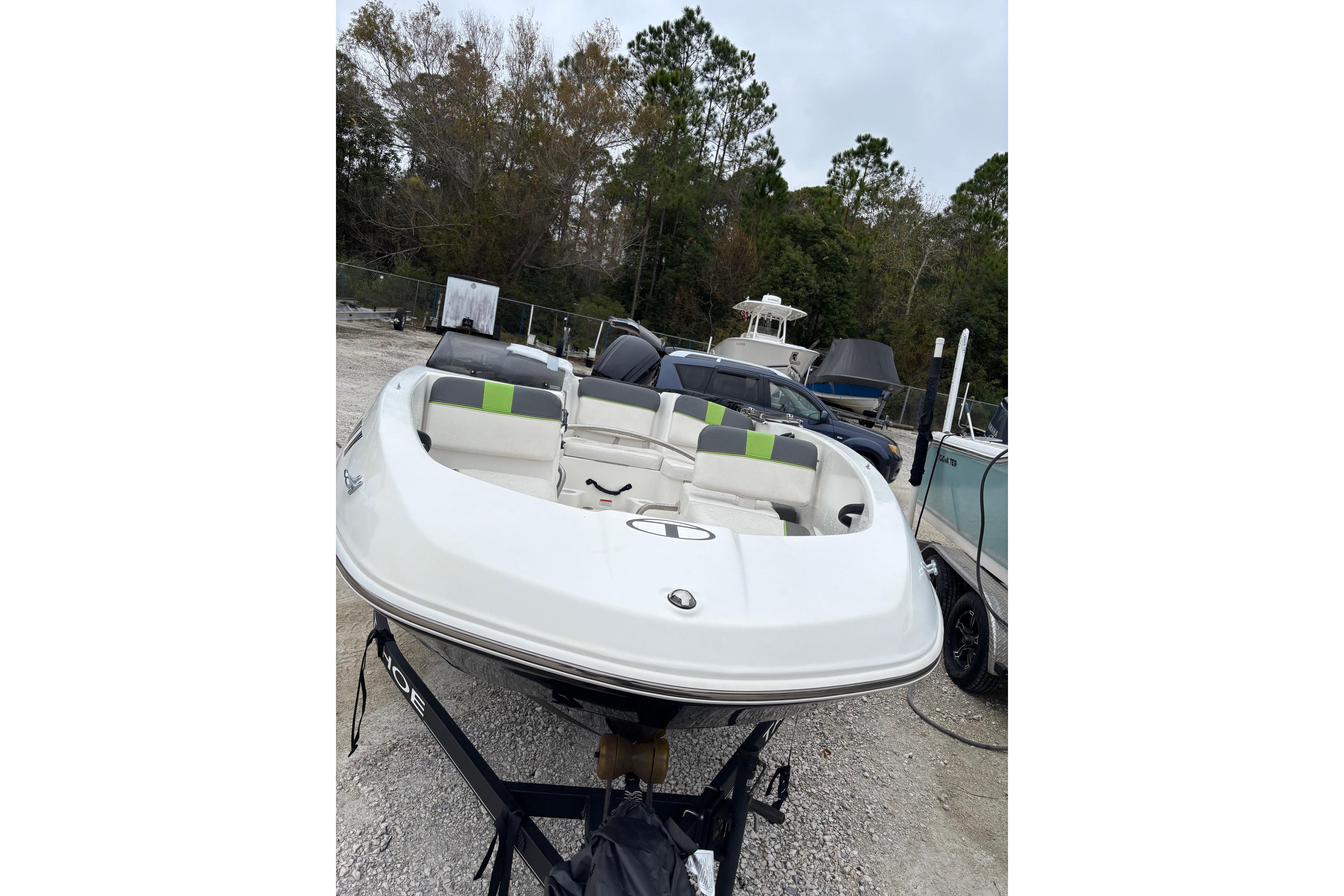 2022 Tahoe T16 boat on trailer in outdoor storage area.
