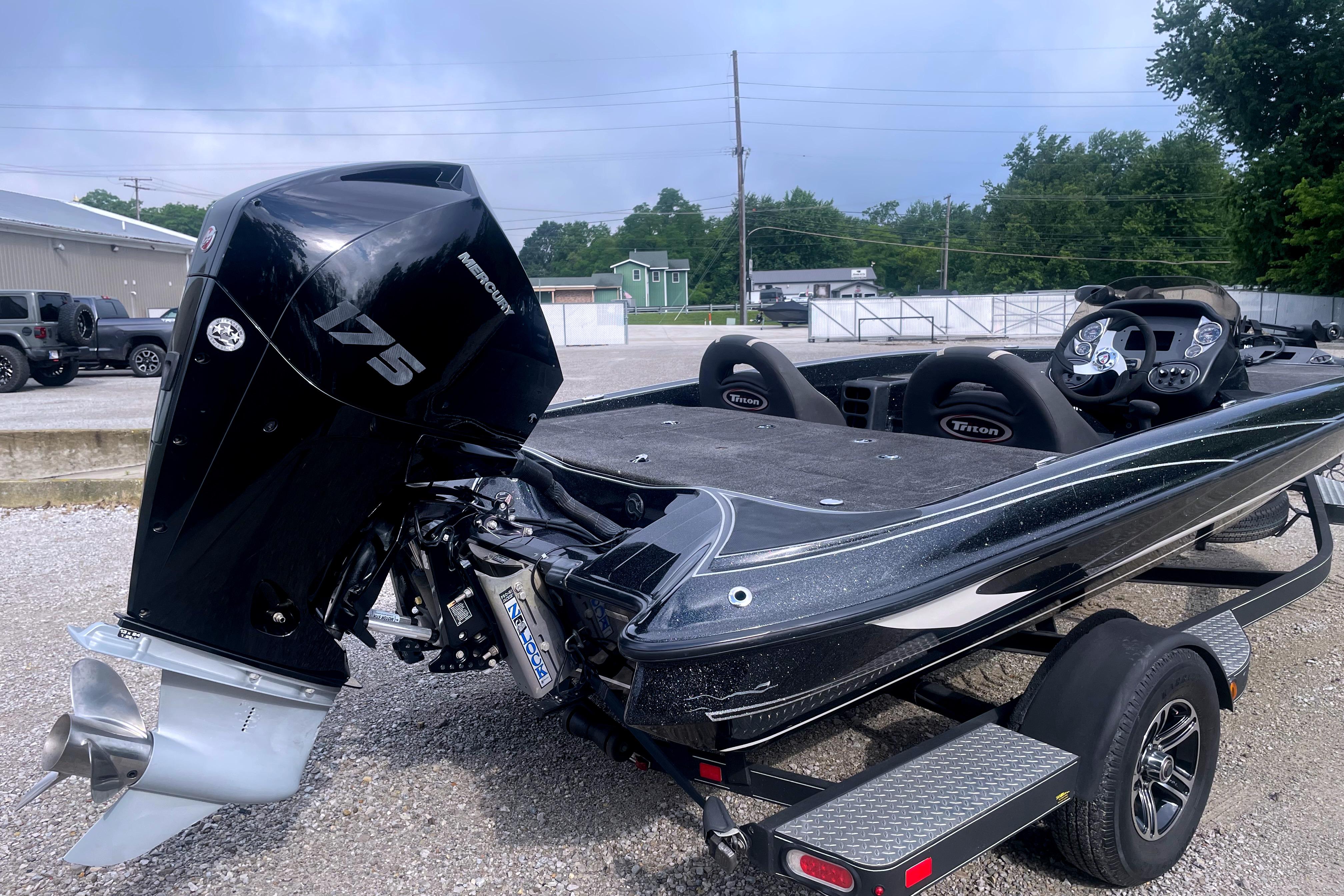 2022 Triton 18 TrX bass boat with Mercury 175 engine, parked on a trailer.