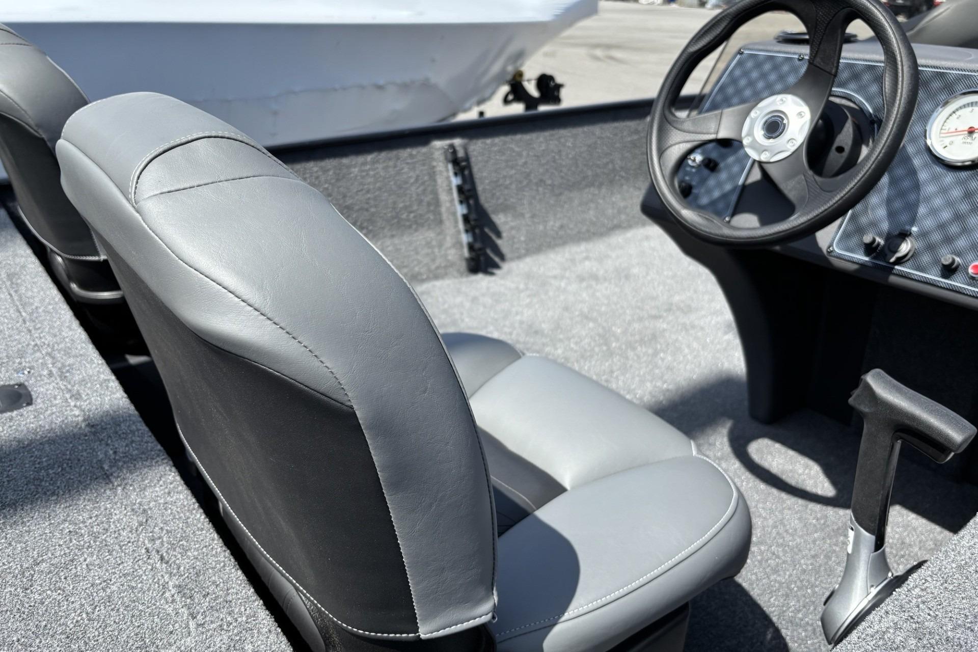 2026 Tracker Bass Tracker Classic XL boat interior with steering wheel and gray seats.