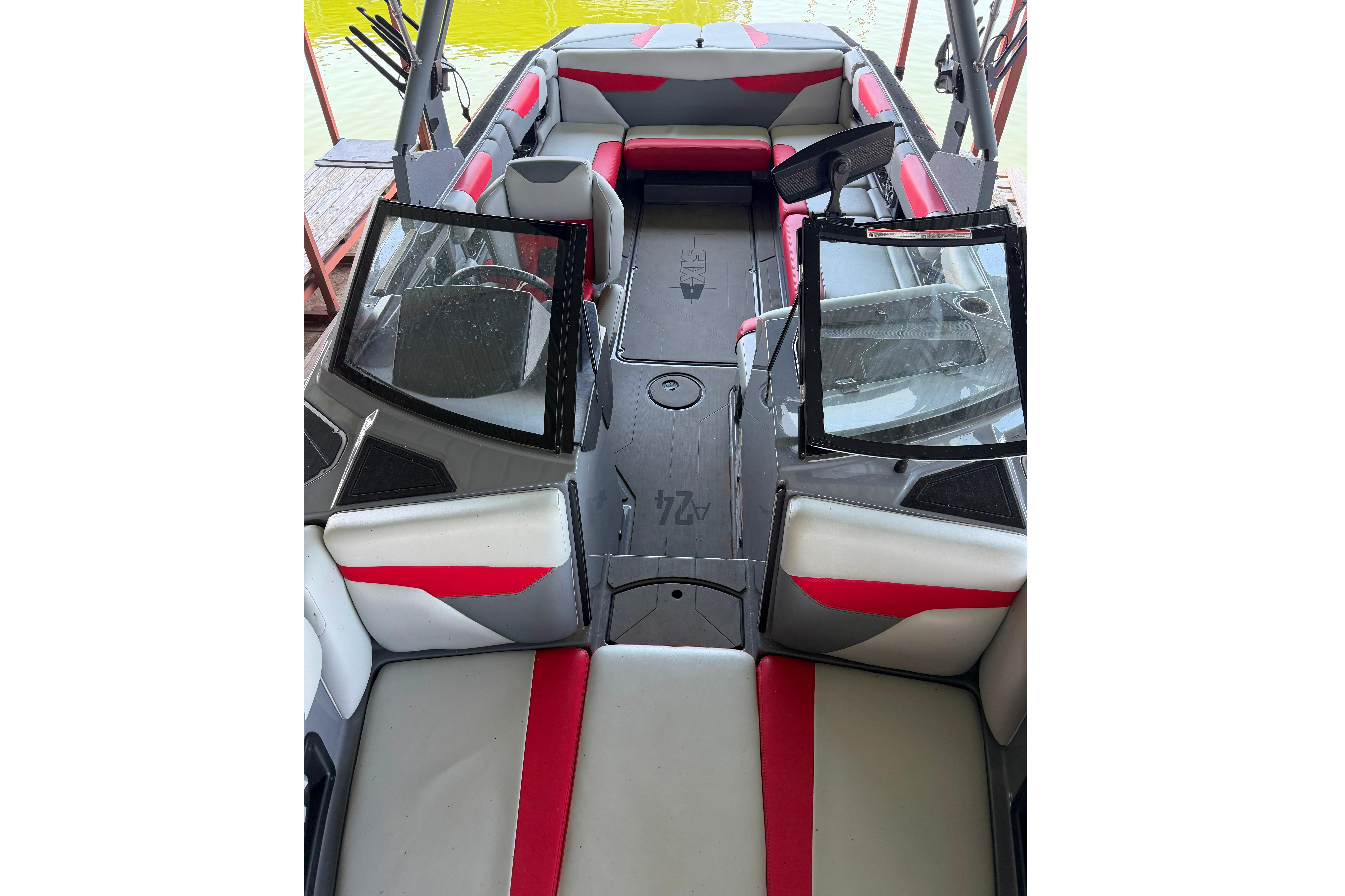 2021 Axis A24 boat interior with red and gray seating, open windshield, and spacious layout.