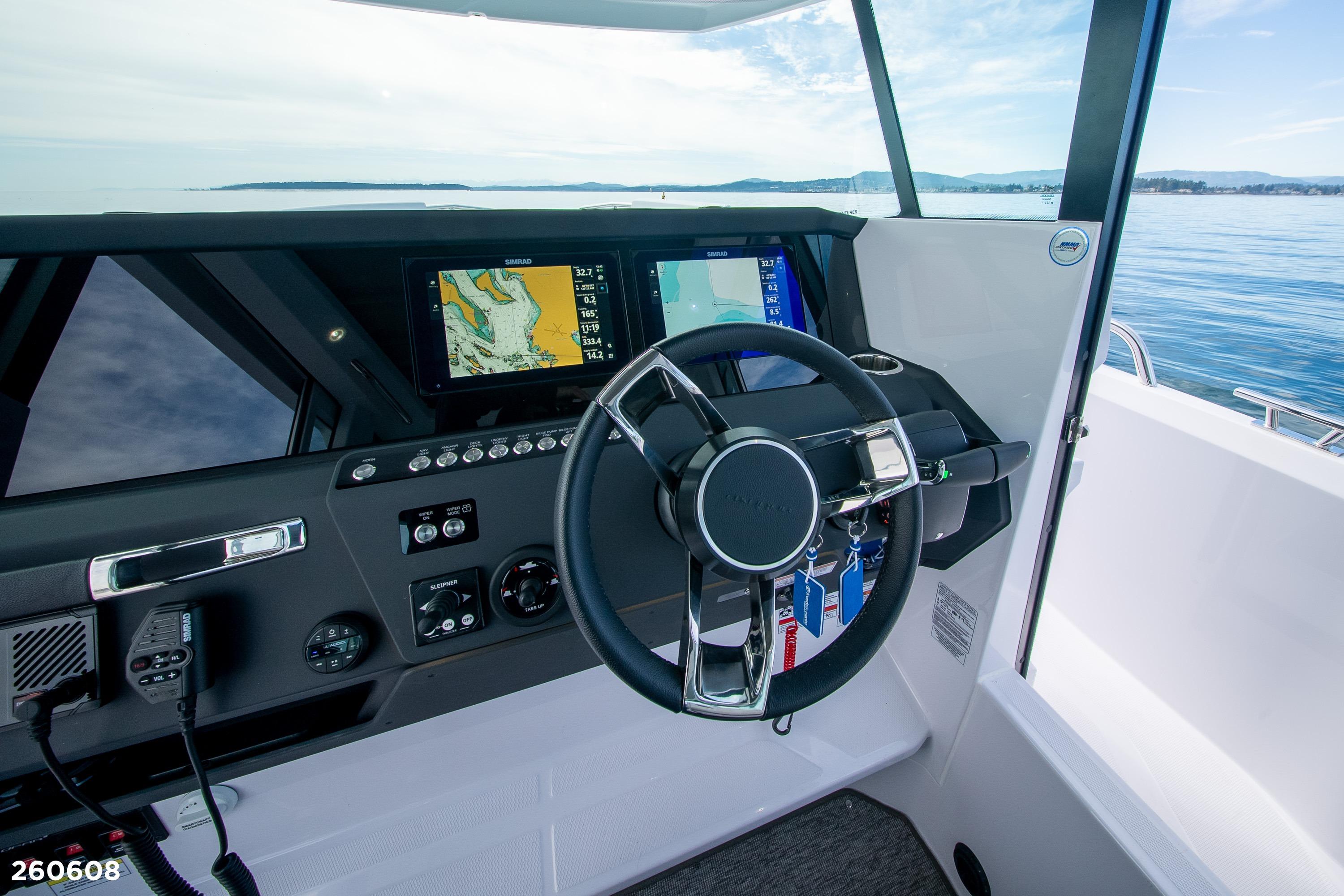 2026 Axopar 29 XC Cross Cabin helm with navigation screens and steering wheel.