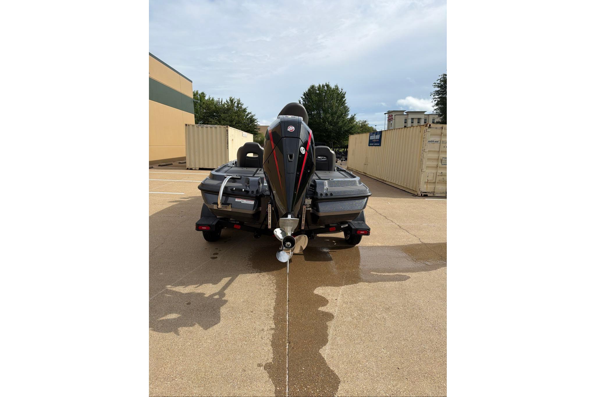 2026 Nitro Z20 XL boat rear view in parking lot, showcasing powerful engine and sleek design.