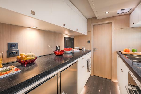 Modern kitchen interior on 2025 Privilege Signature 650 yacht, featuring sleek countertops and cabinetry.