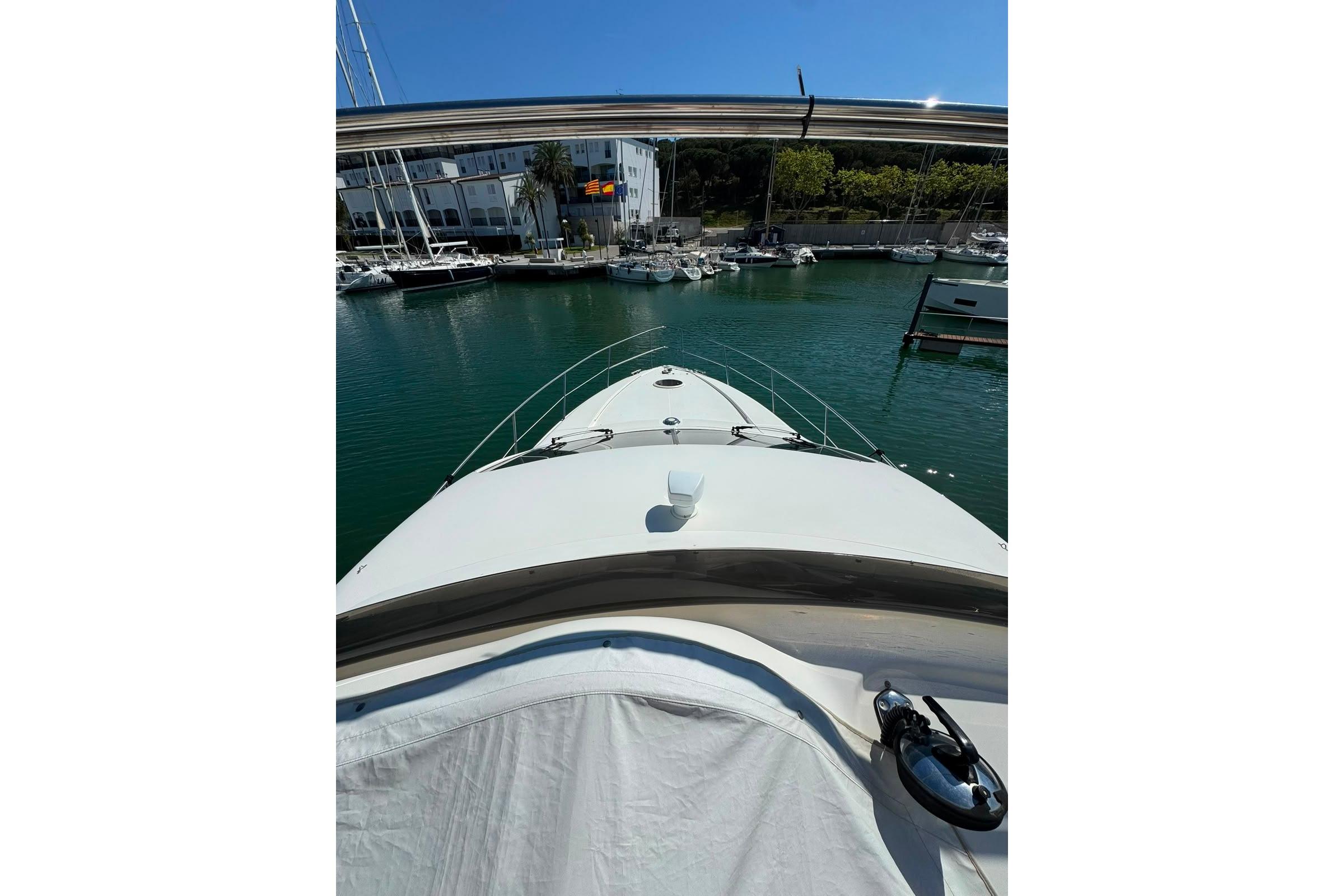 Front view of a 2001 Azimut 46 yacht docked in a marina.
