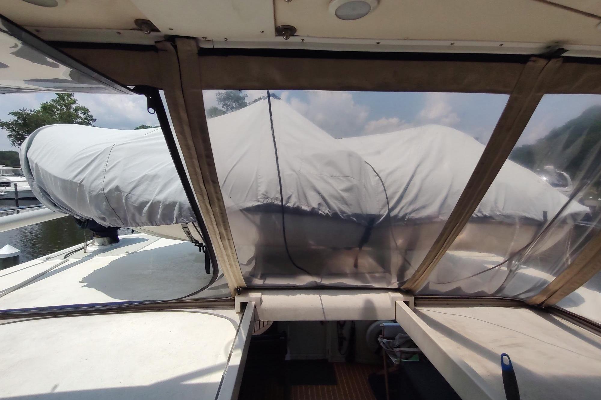 1989 Hyatt Double Cabin Motoryacht deck view with covered equipment and clear canopy.
