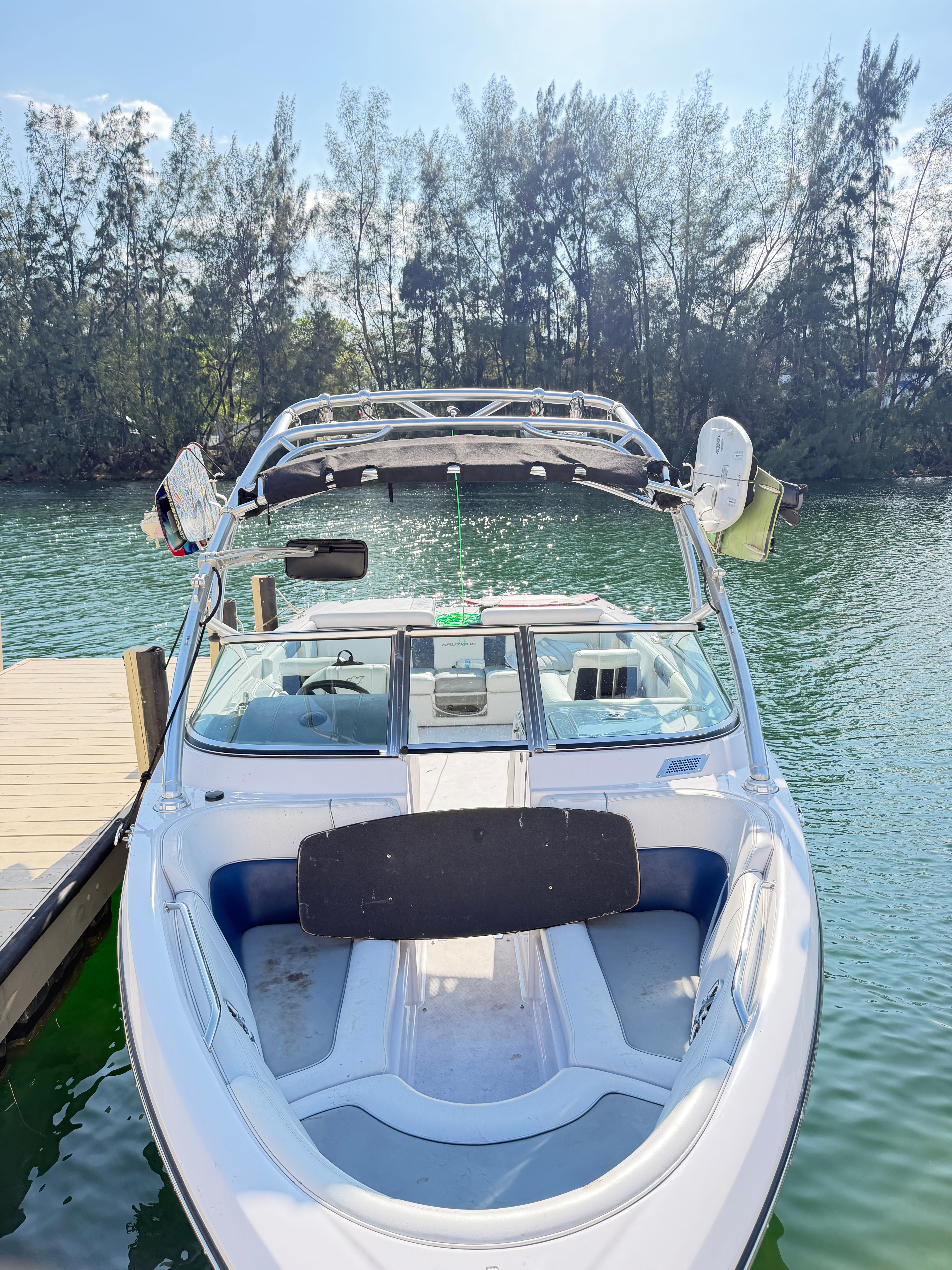 2008 Nautique 236 Team Edition boat docked on a sunny day.