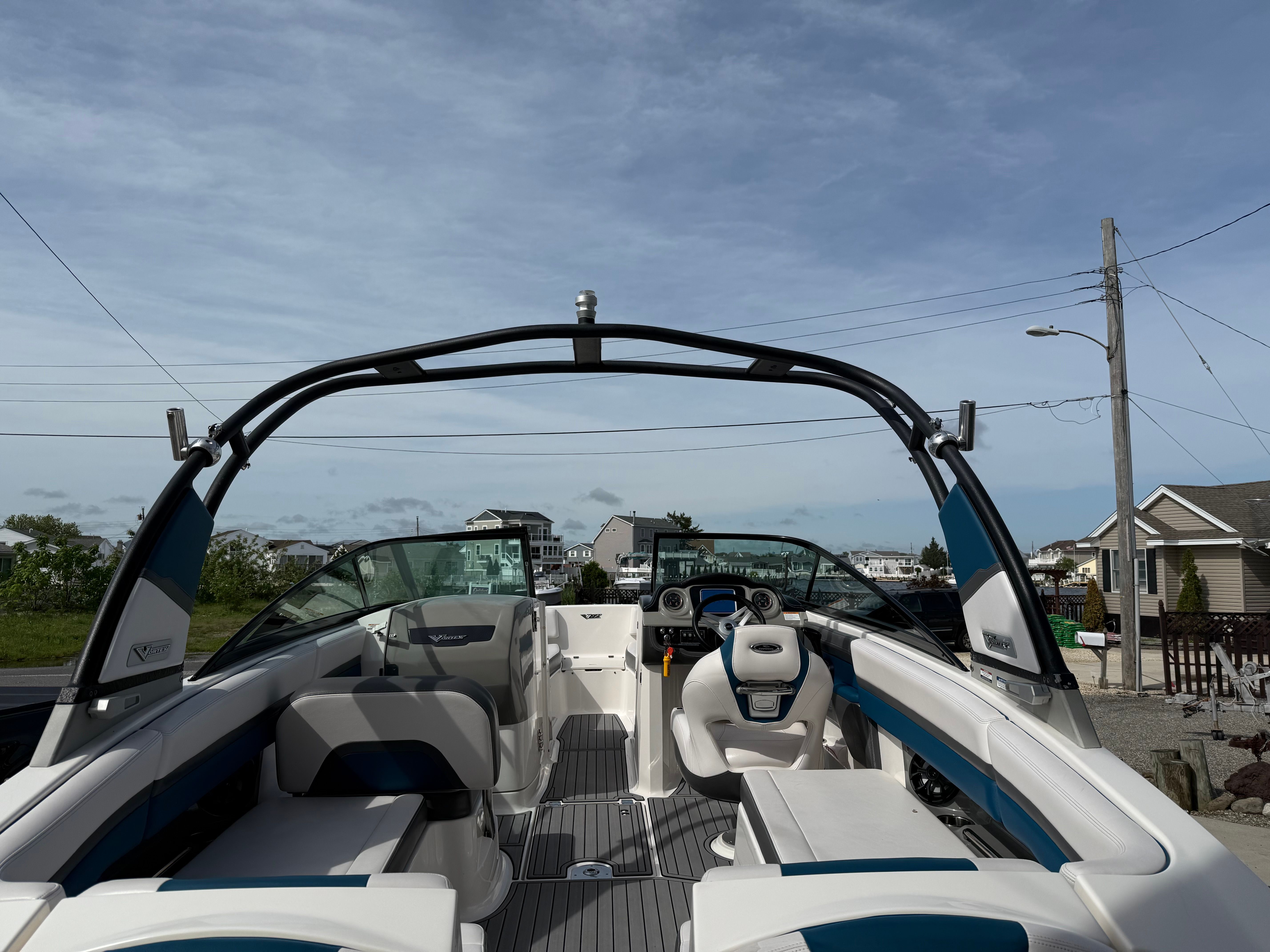 The image shows a 2016 Chaparral Vortex 243 VRX boat with modern seating and an open deck.