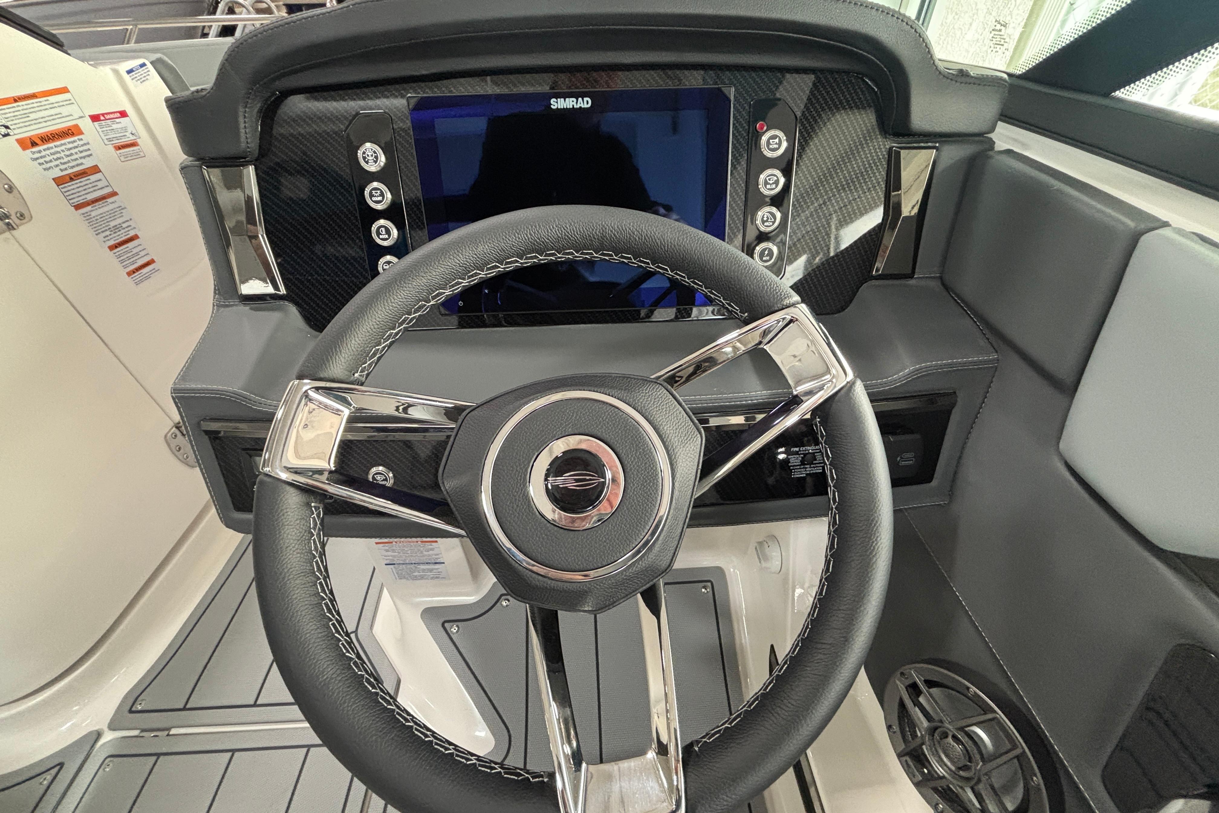 2026 Chaparral SSX 4 boat dashboard with steering wheel and Simrad display.