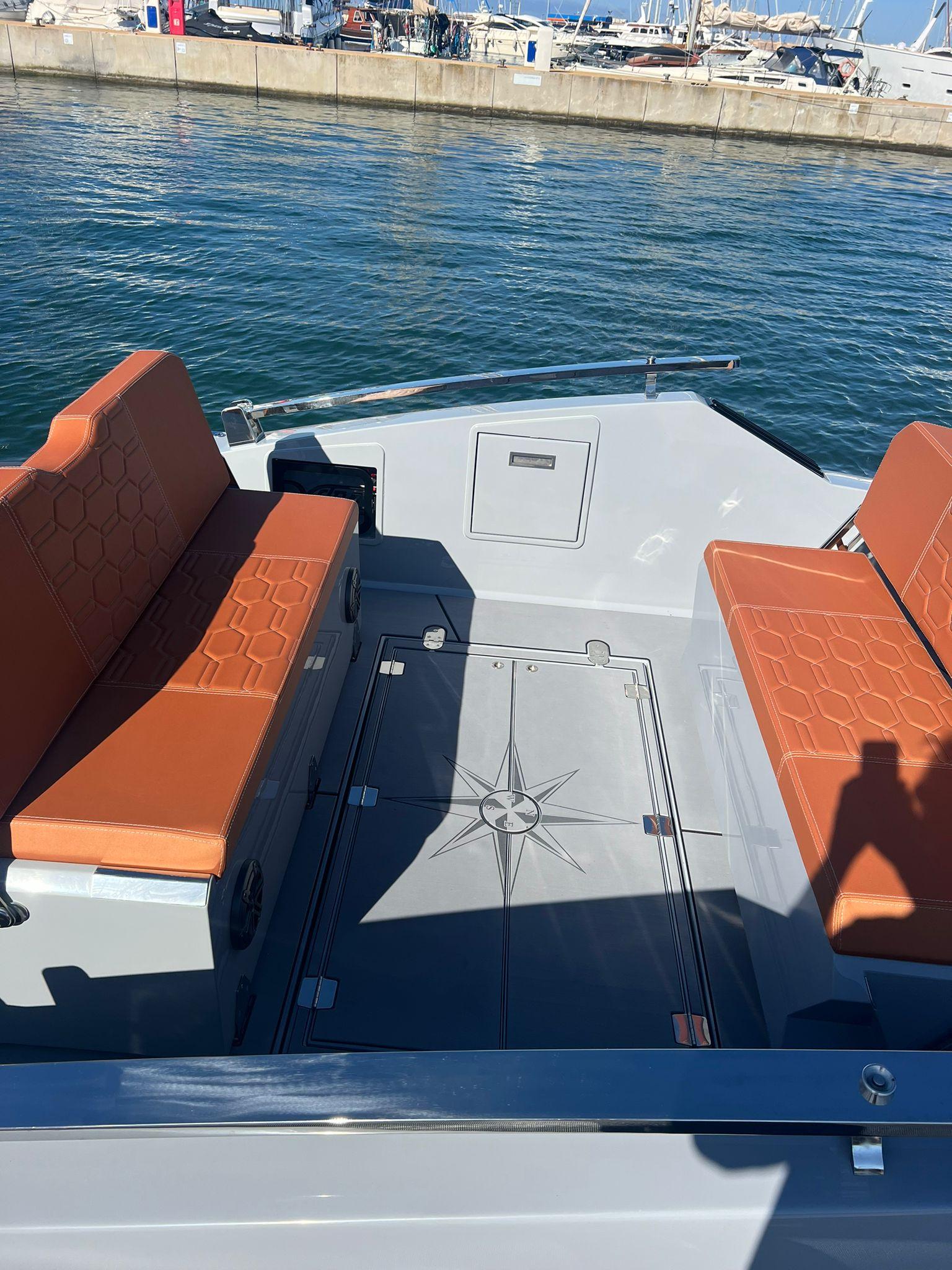 2025 DNA 46 boat with orange seats docked at marina.